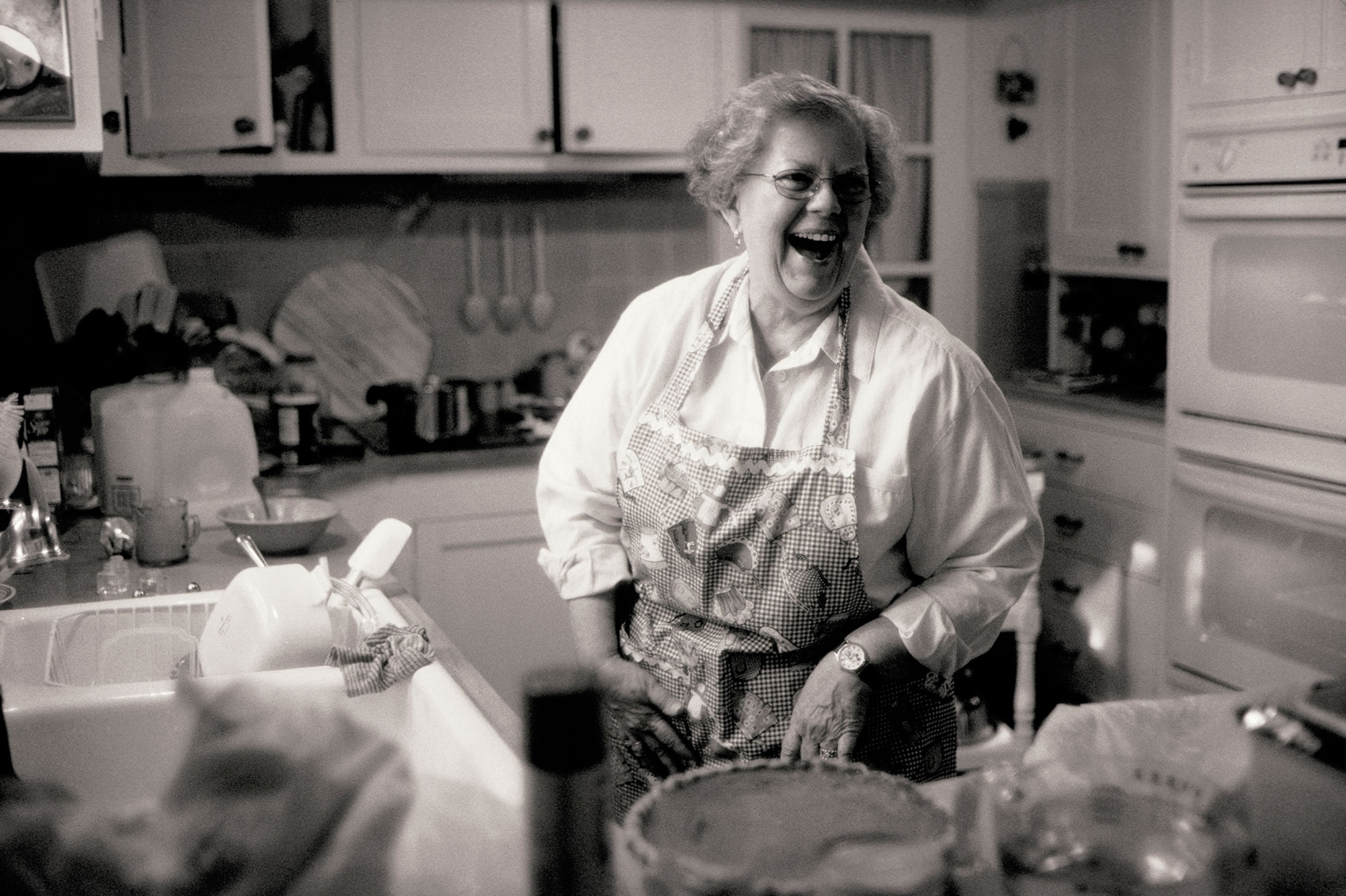 woman laughing in kitchen