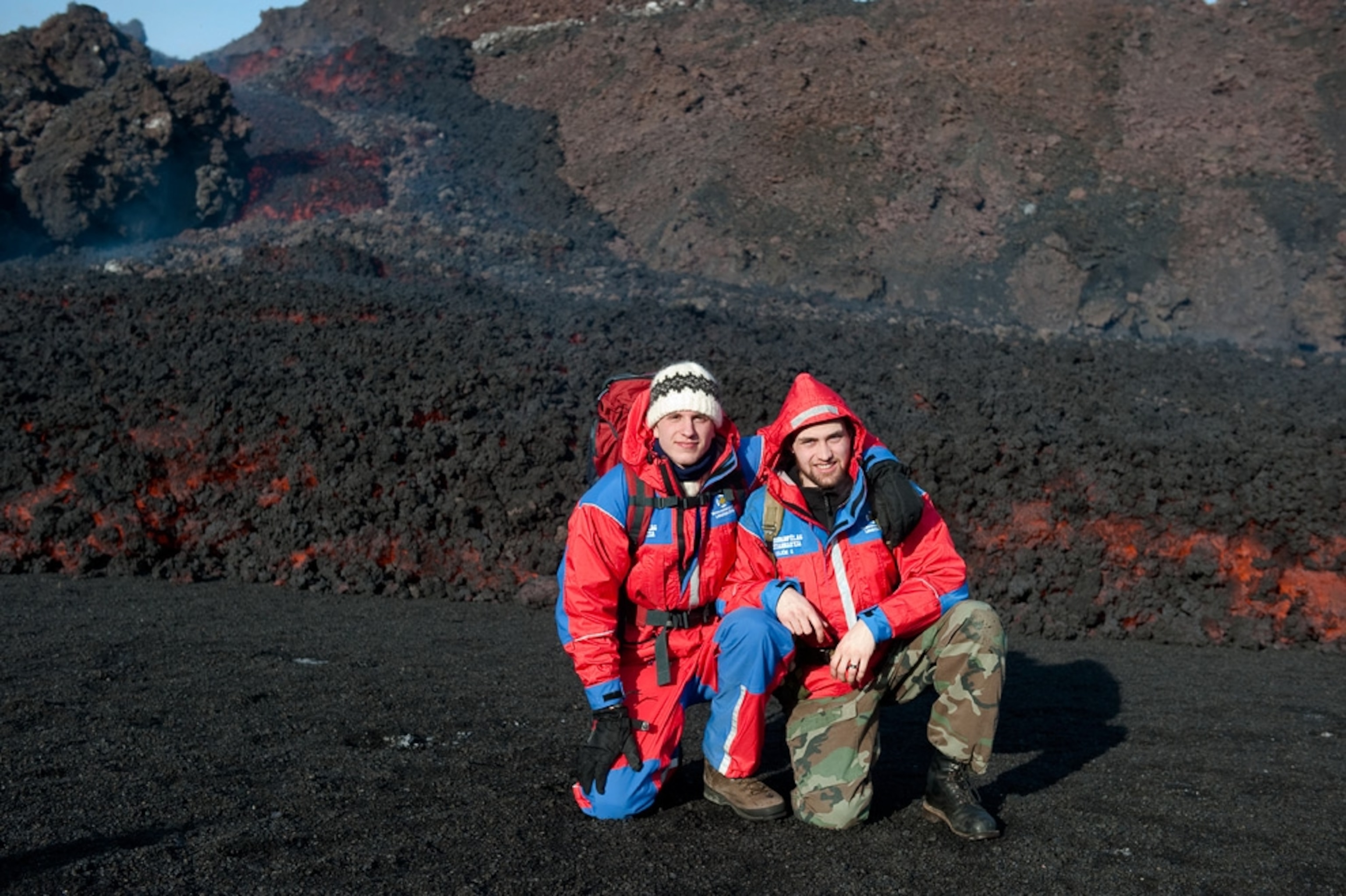 Two tourists pose for a picture near cooling lava at the Eyjafjallajökull volcano.