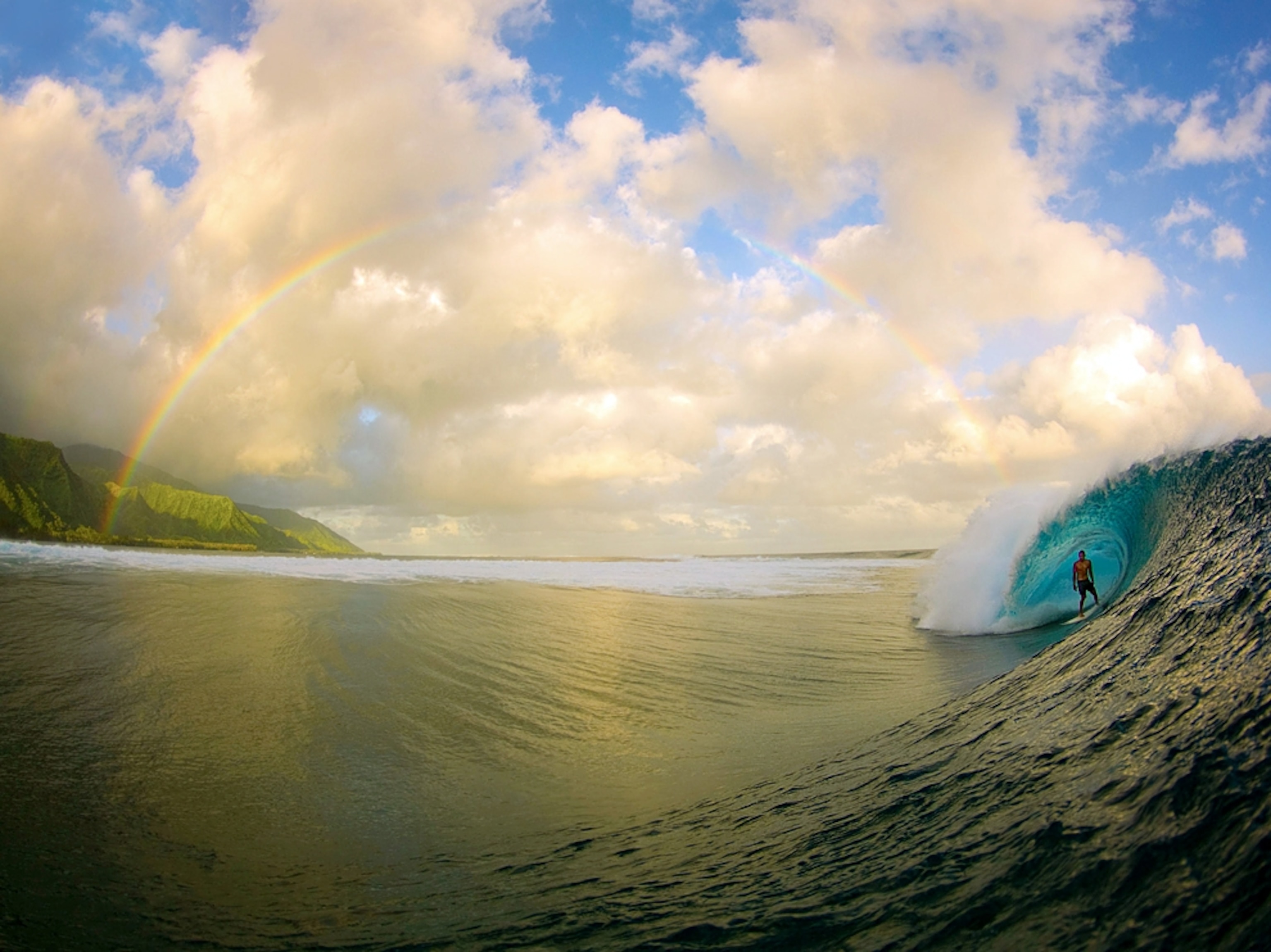 a surfer riding a wave at Teahupoo break, Tahiti
