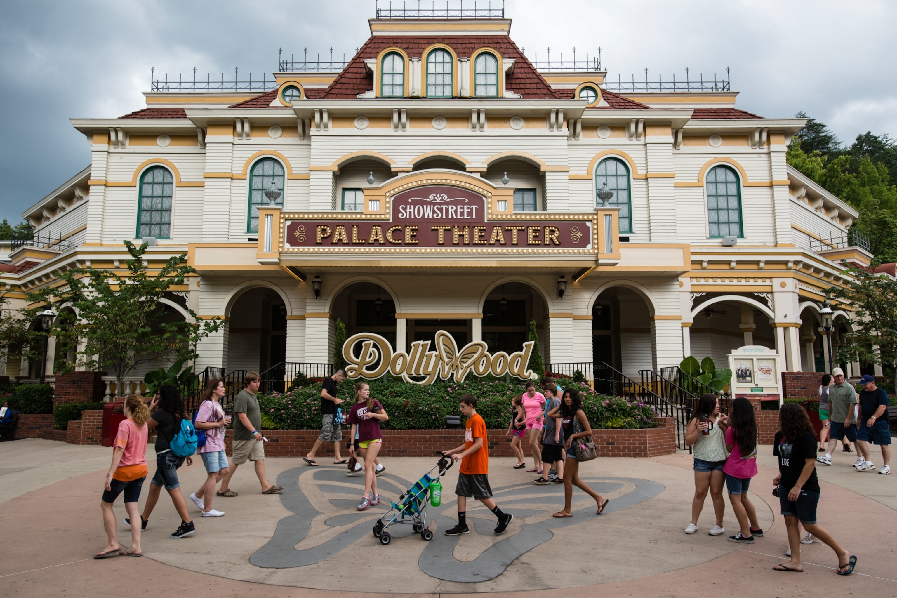 A group of people walk past a building.