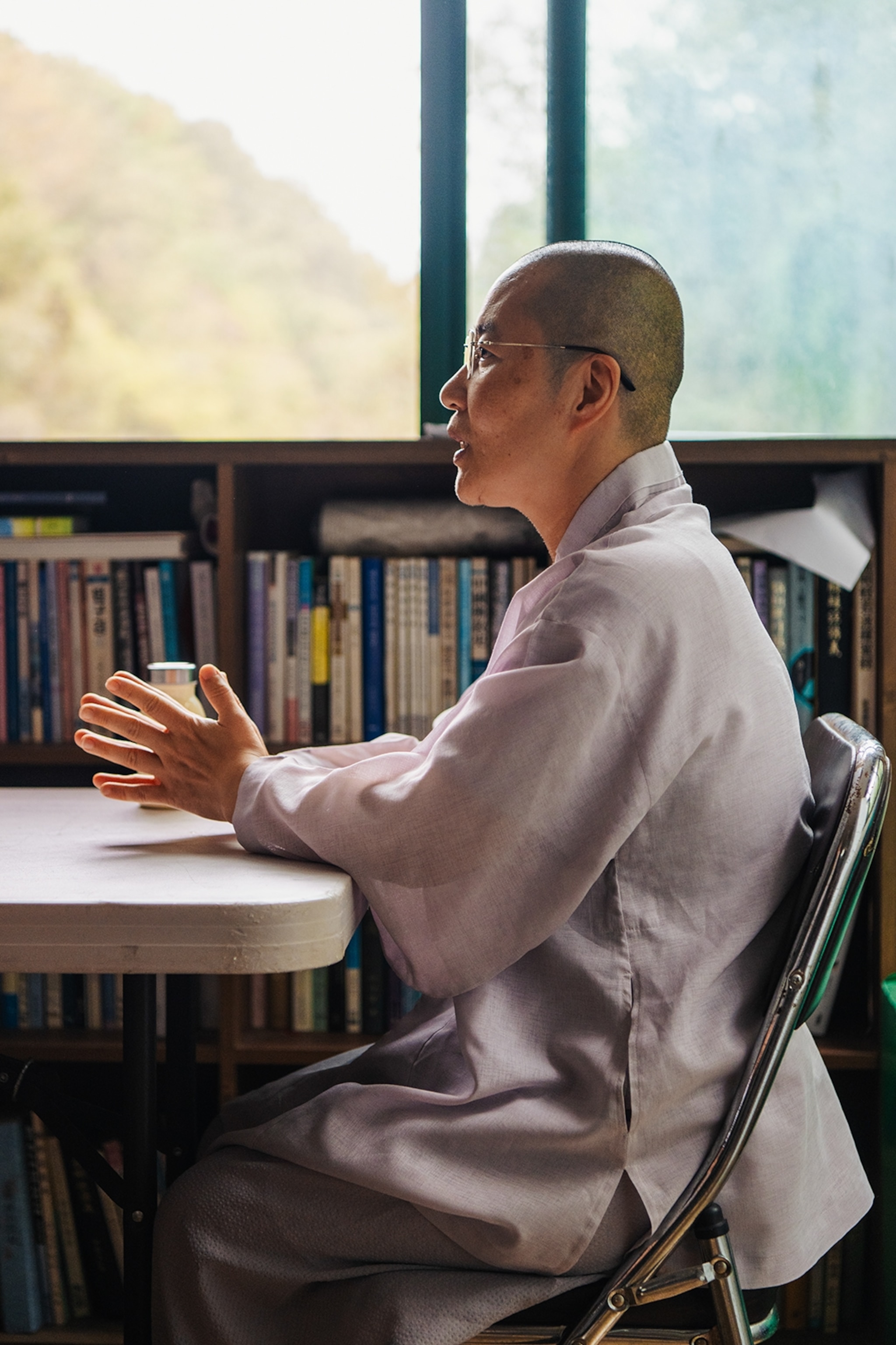 Monk sits at a table in the temple.