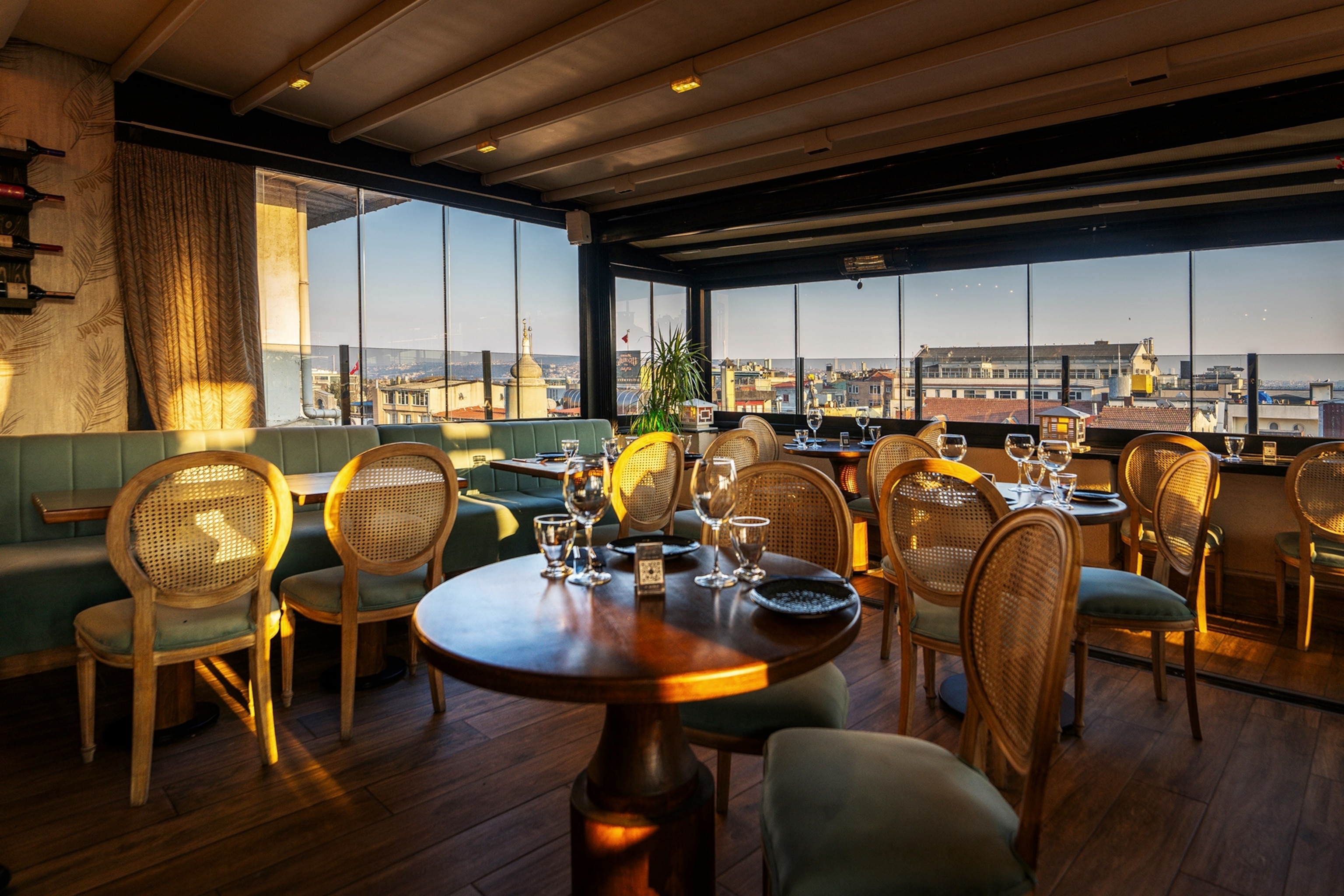 An indoor rooftop restaurant with impressive views over the city below.