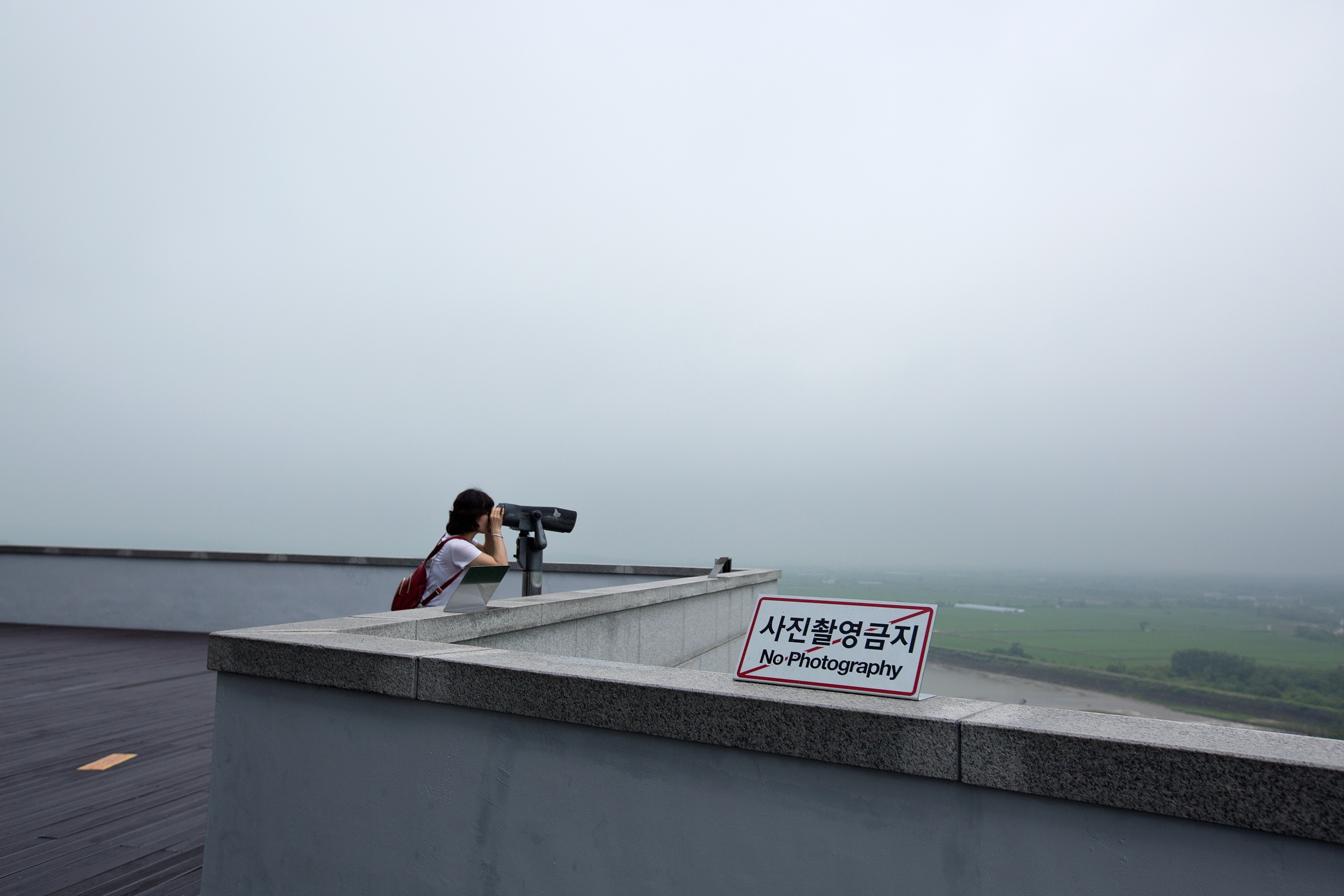 a tourist at an observation post along the Demilitarized Zone in South Korea