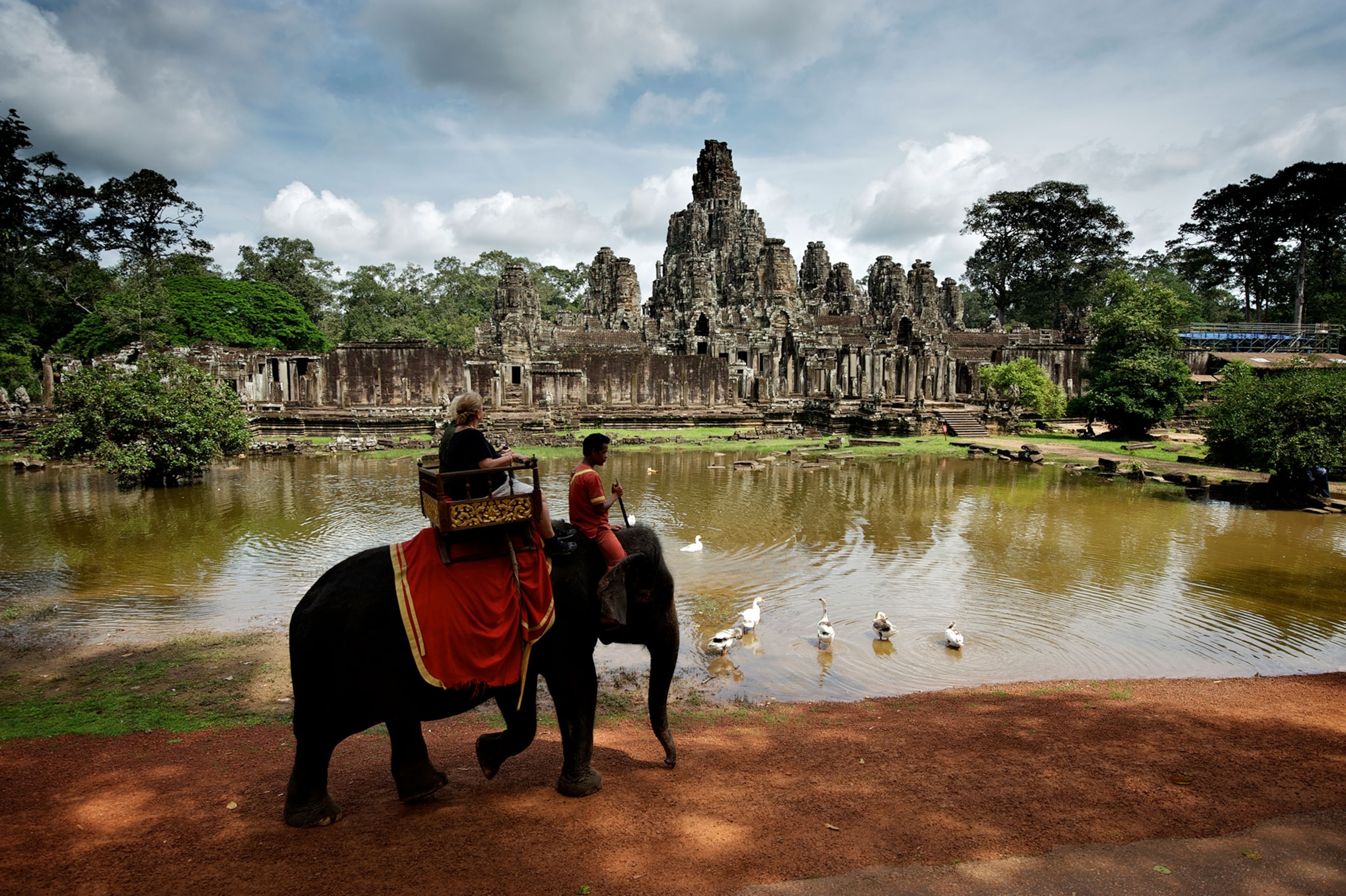 tourists riding an elephant near Angkor Wat