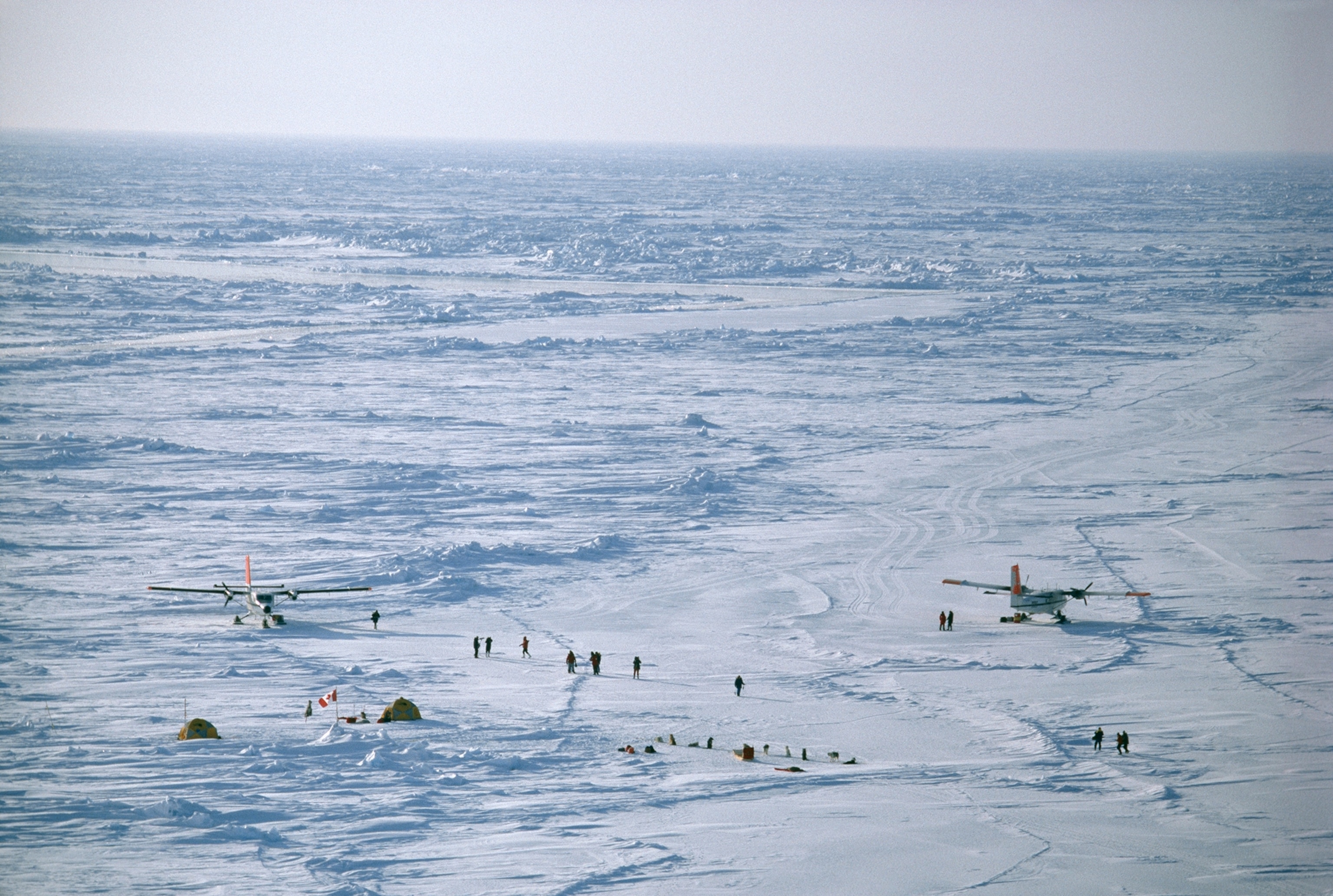 Having reached the North Pole jubilant explorers await transport.
