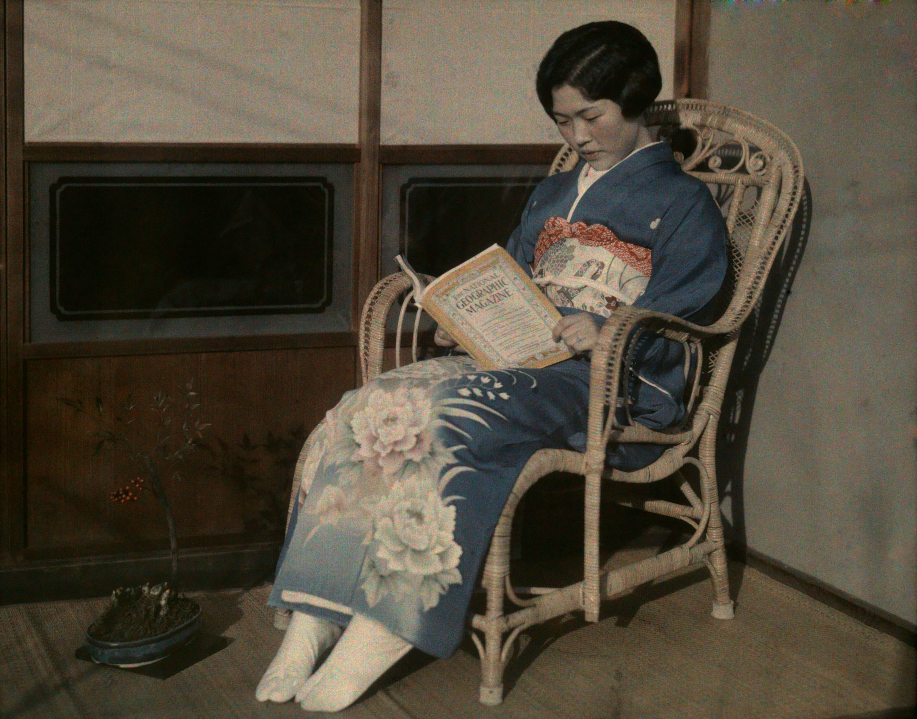 a Japanese girl reading National Geographic Magazine