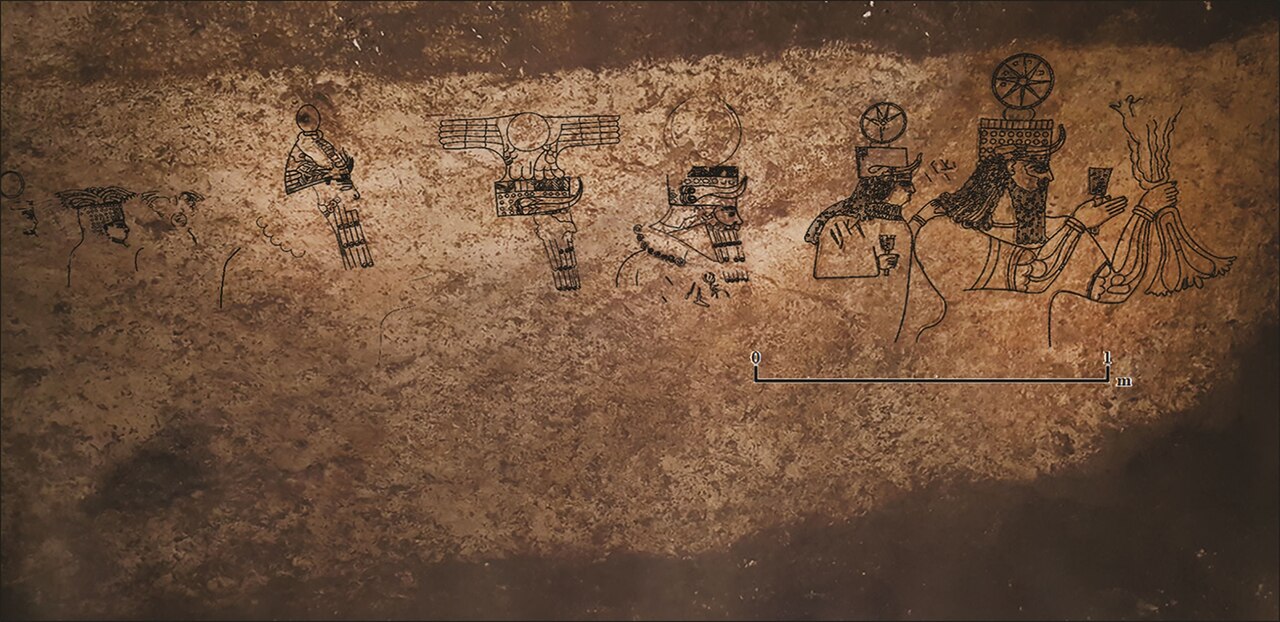 a drawing carved into stone showing a procession of gods with a drawing over it to accentuate the carvings