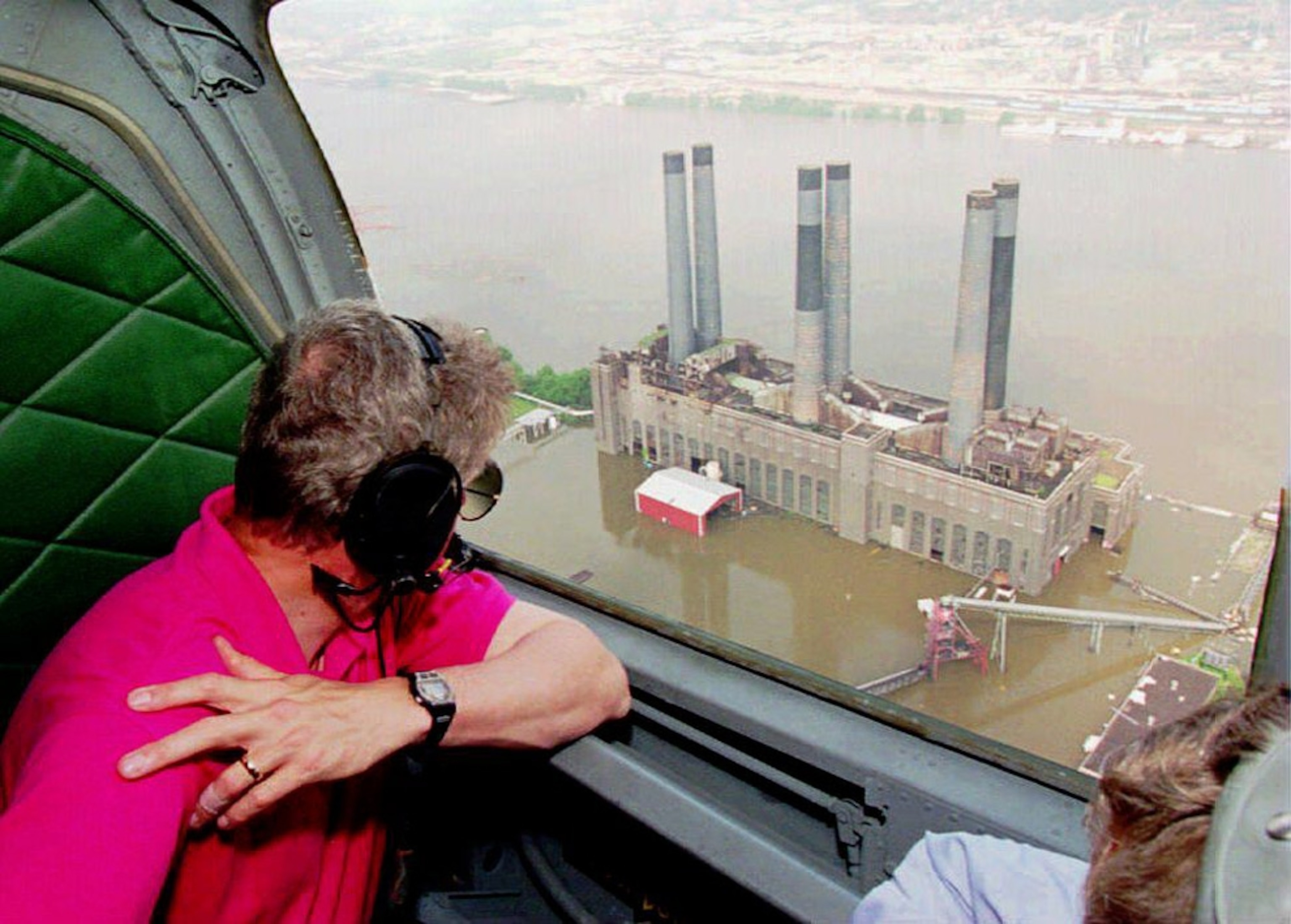 U.S. President Bill Clinton looks at a flooded power plant in the Mississippi- Missouri Rivers near St. Louis 17 July 1993.