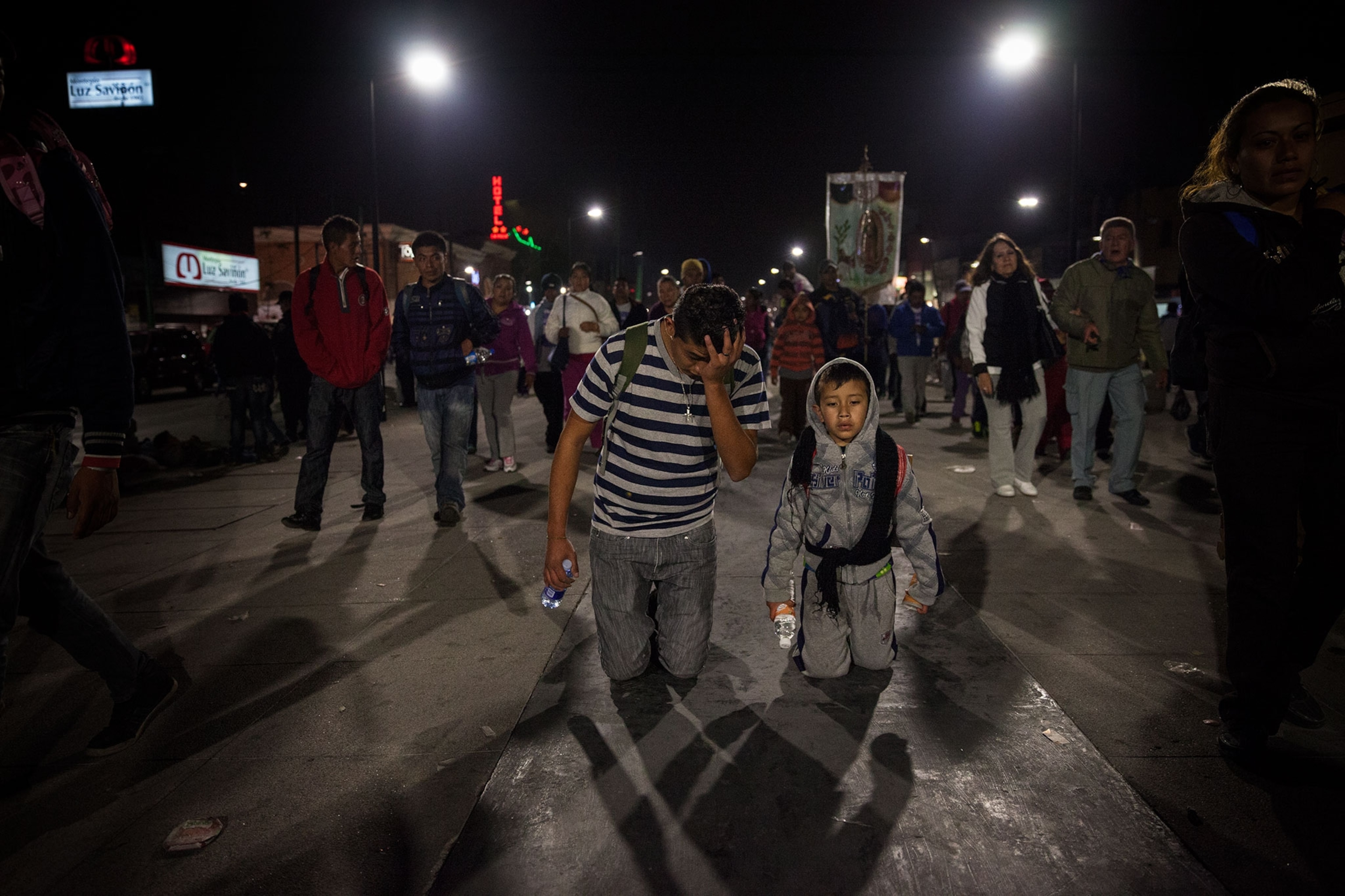 a father and son kneeling in the street.