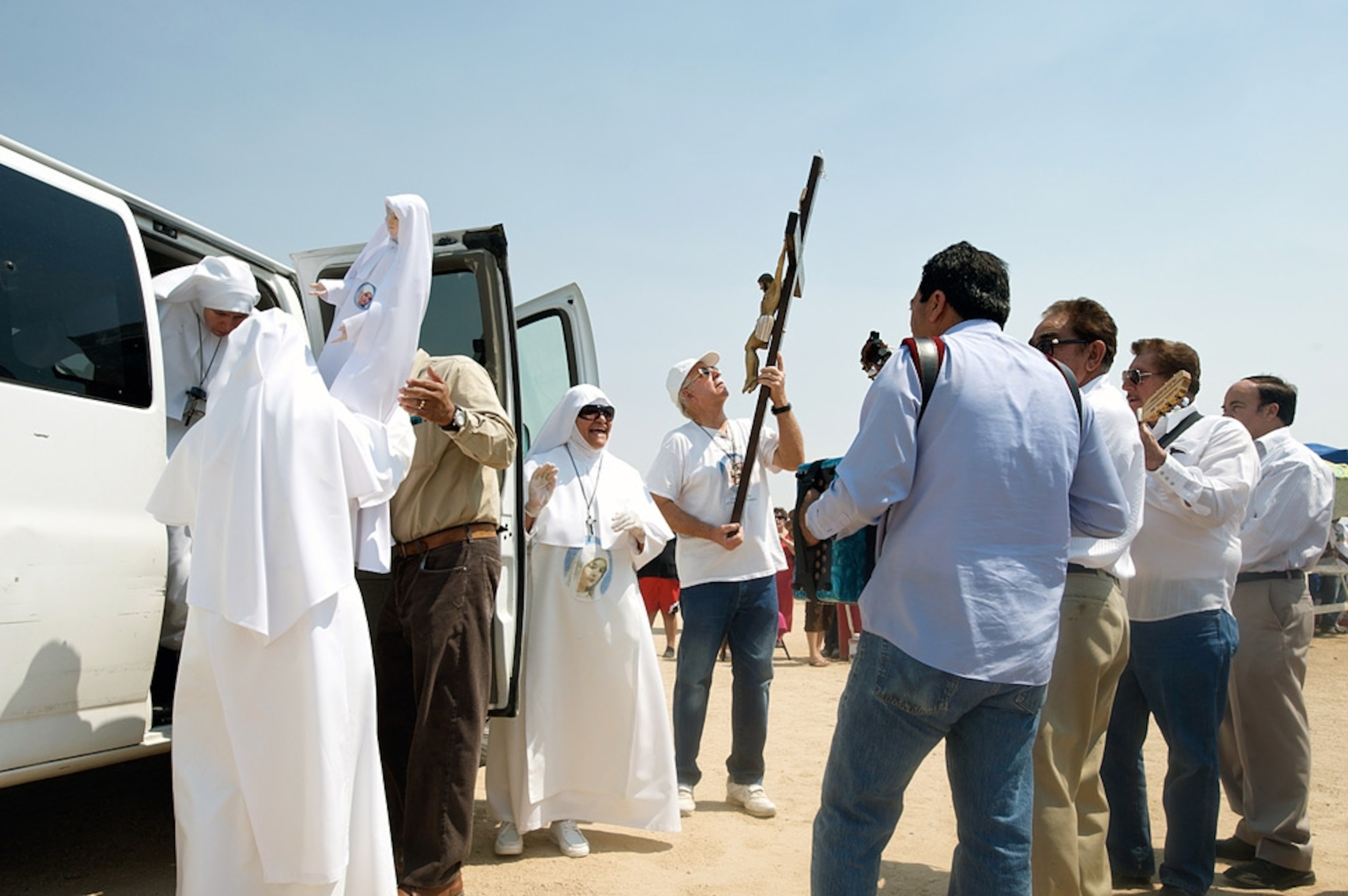 People in religious dress around a van