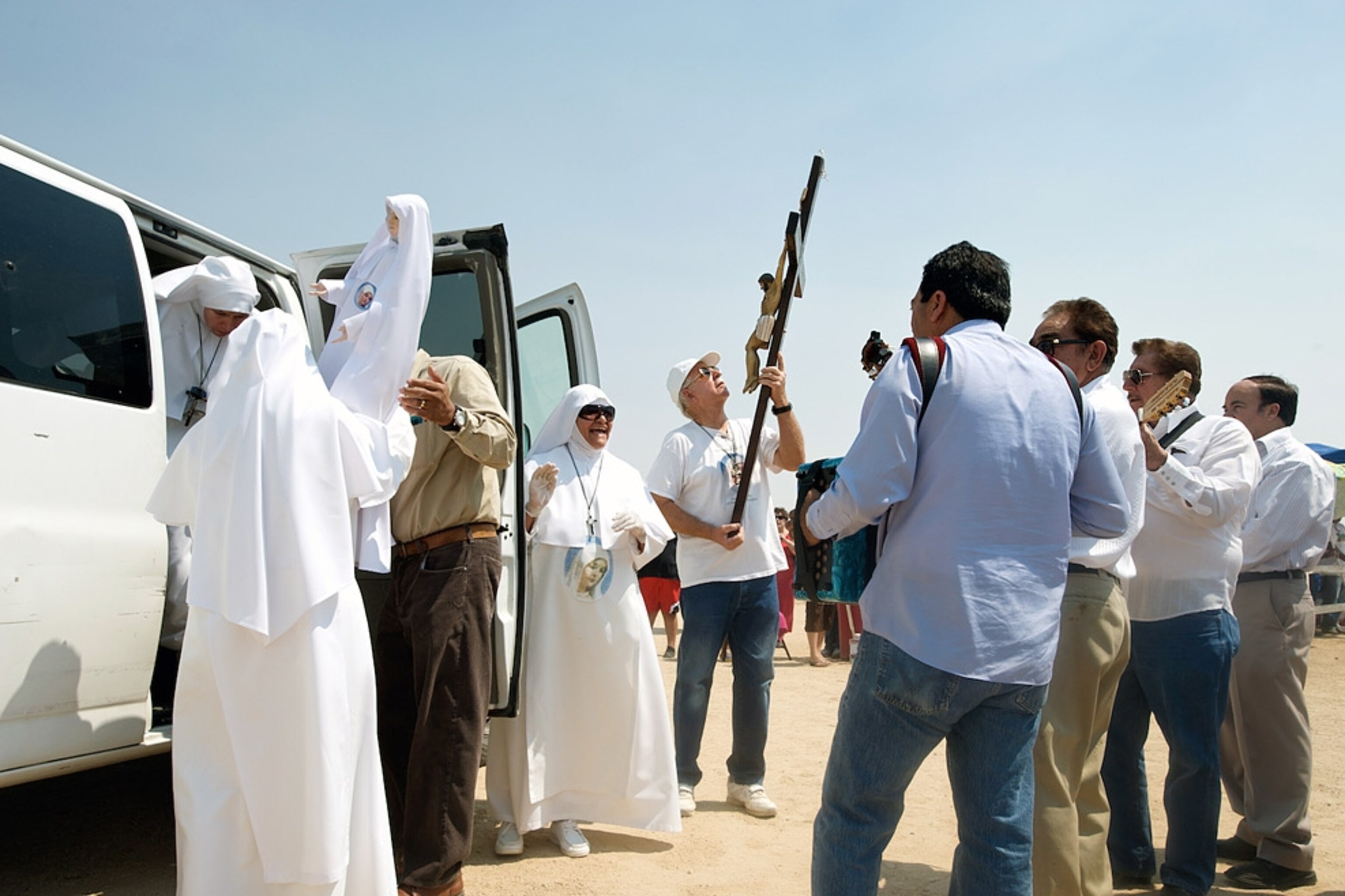 People in religious dress around a van