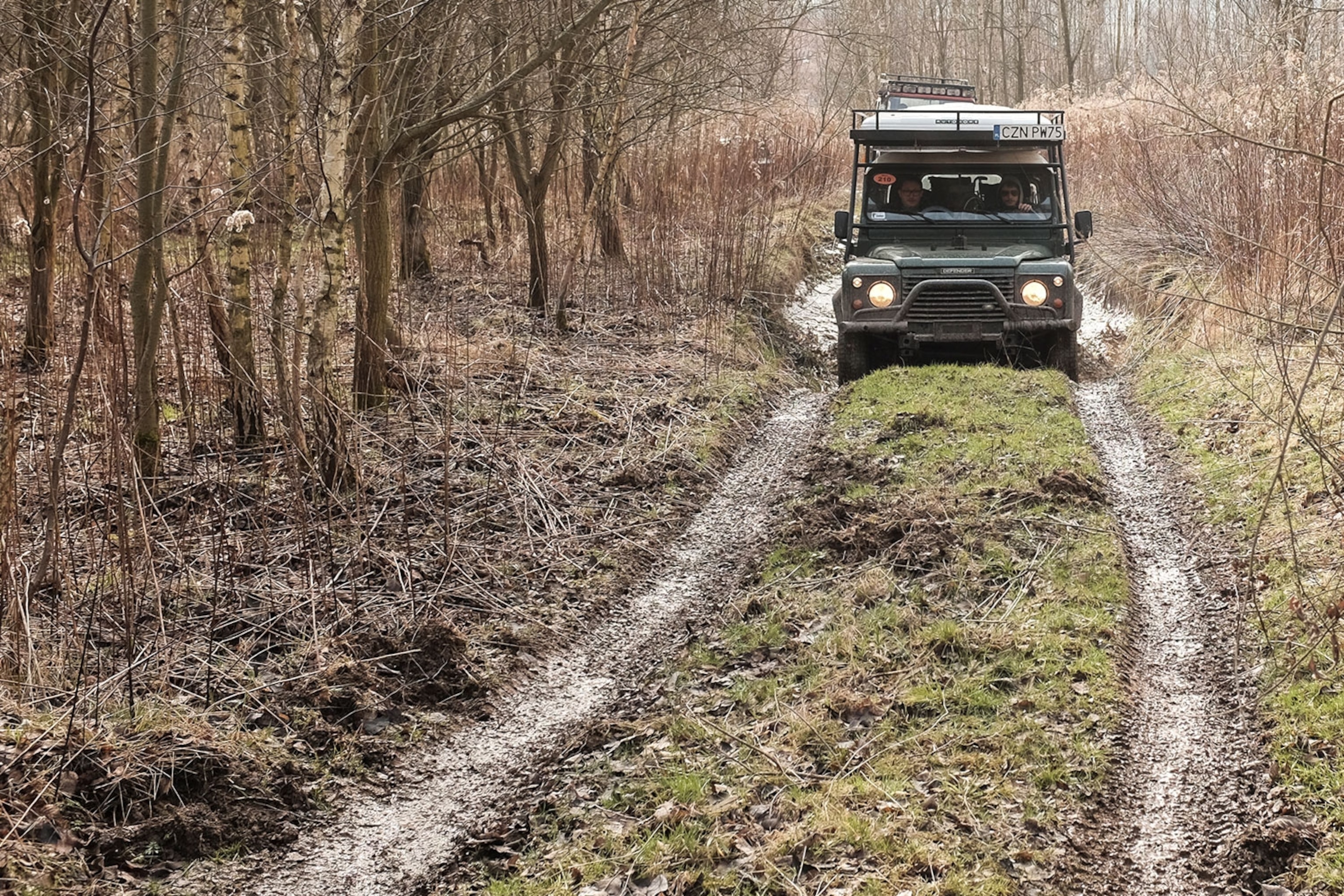 a Land Rover Defender on a country road