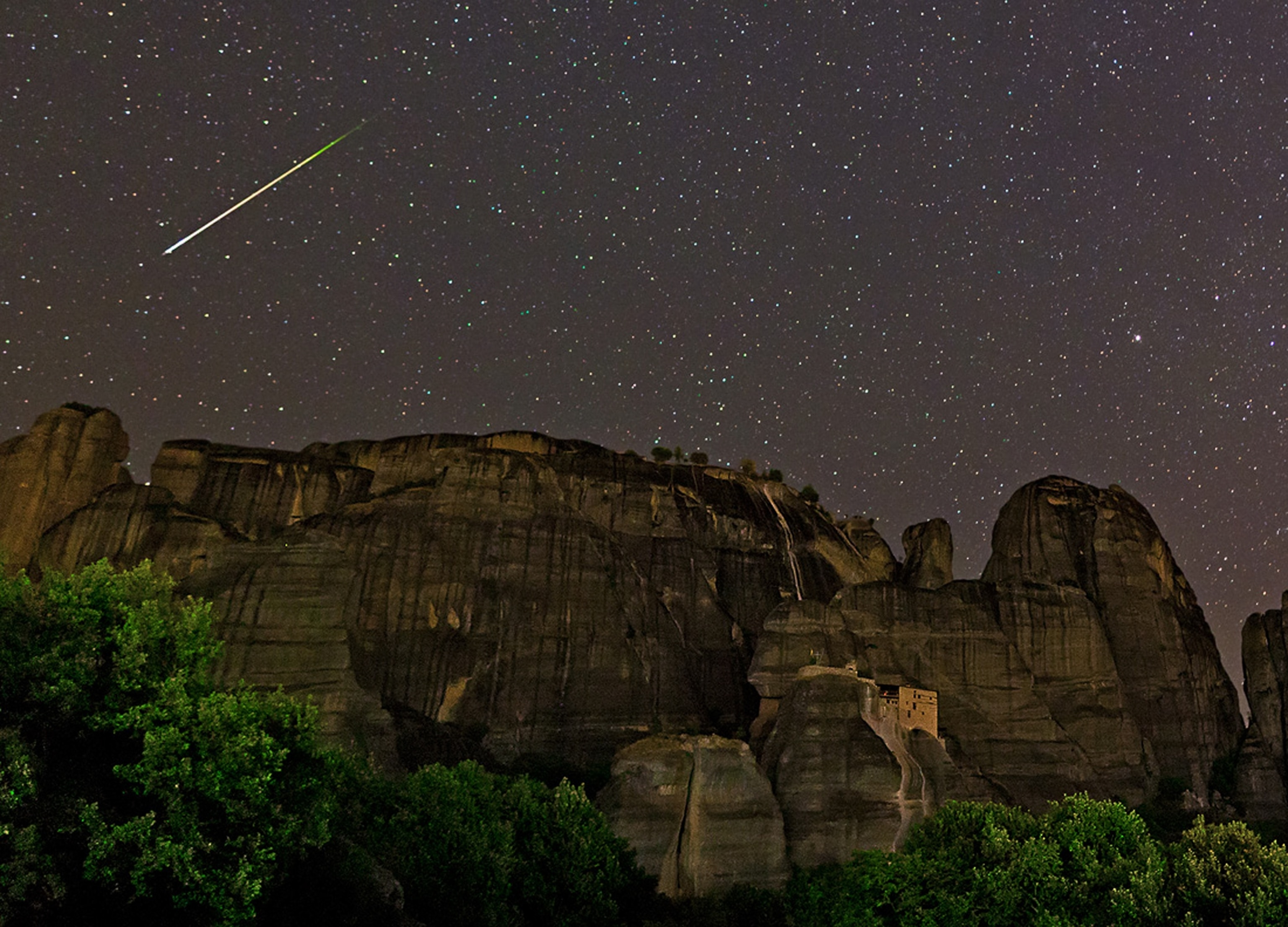 A Perseid meteor over cliff-side monasteries in Meteora, Greece.