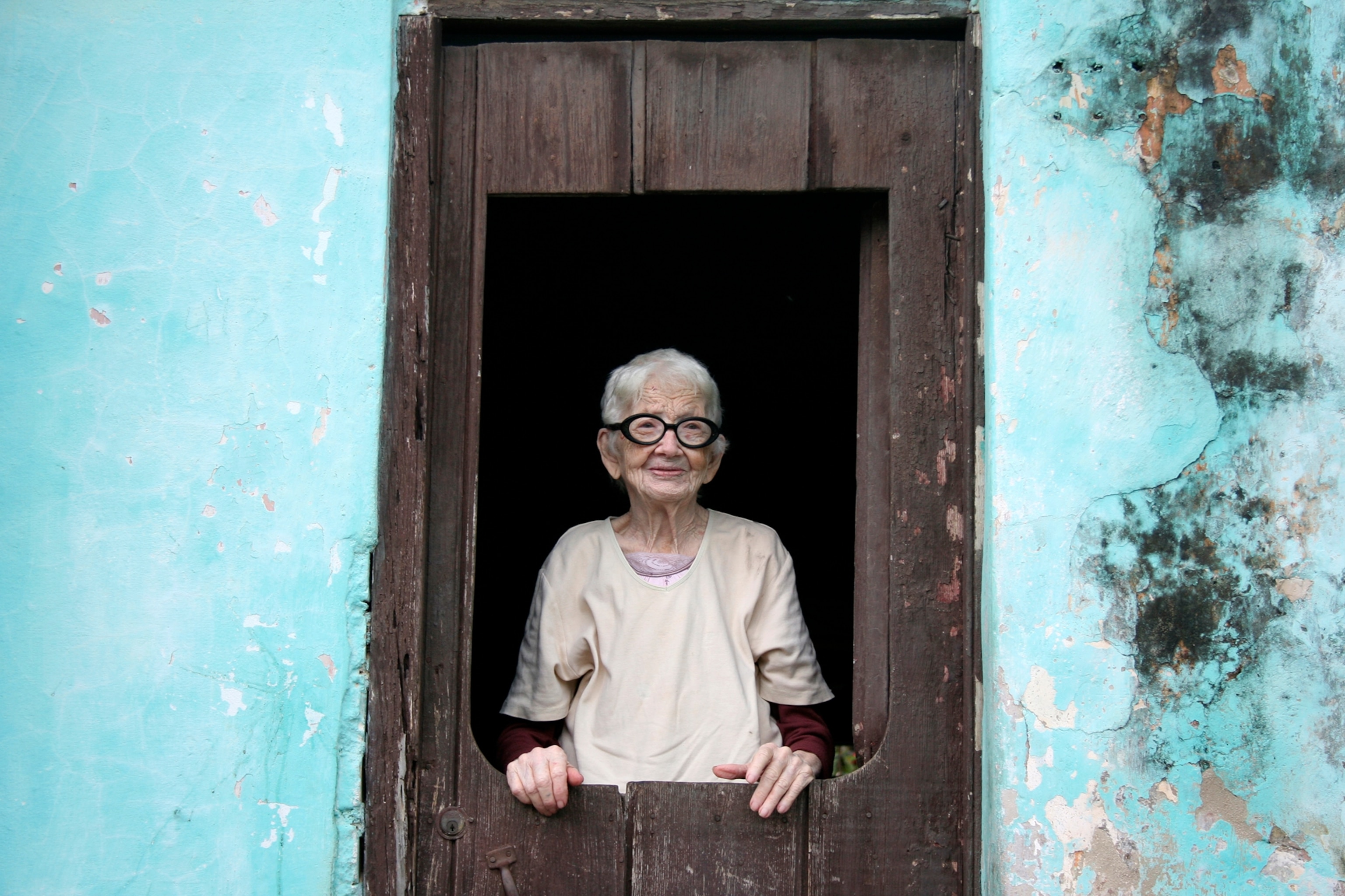 a woman in her doorway in Cuba