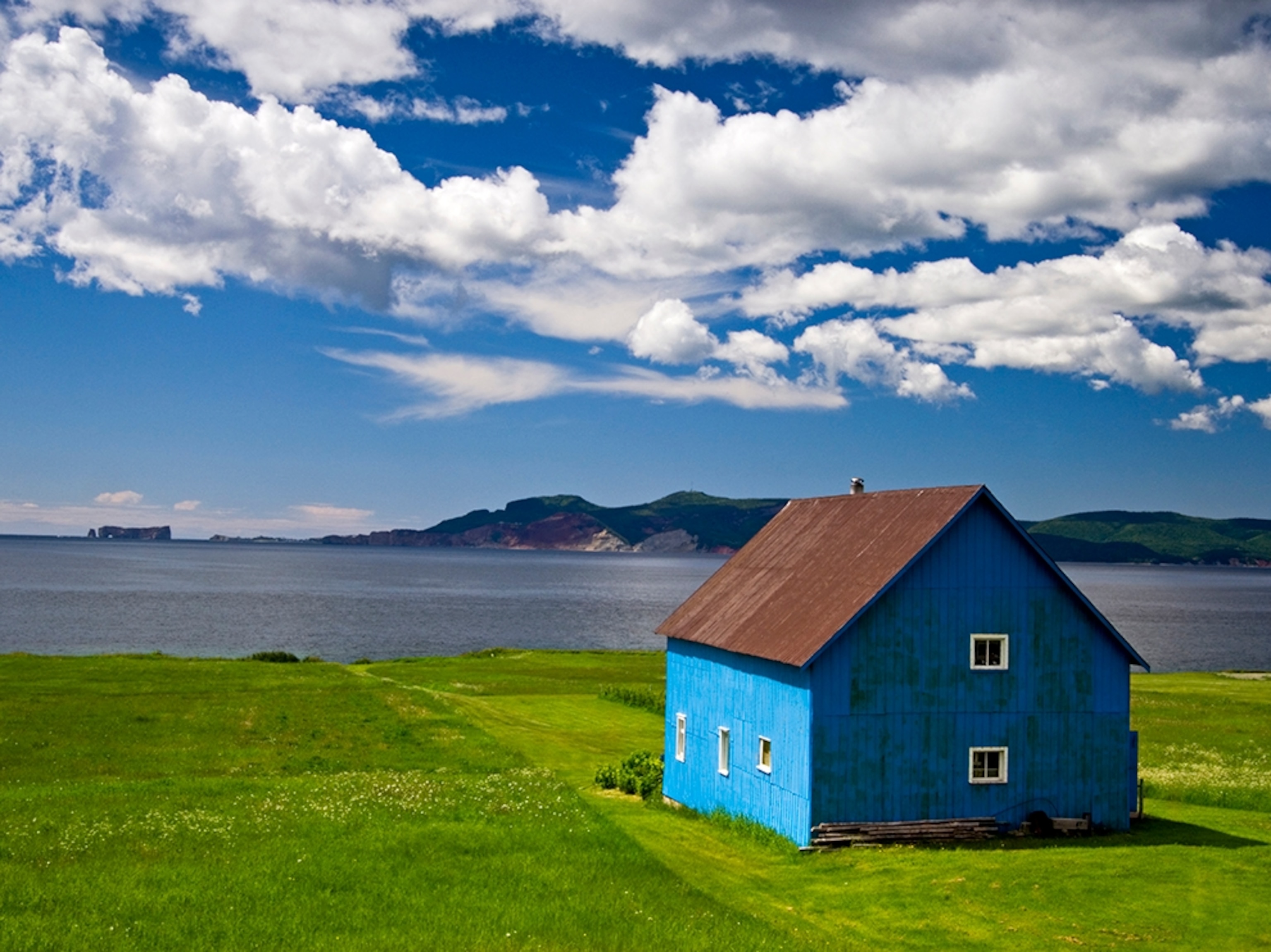 a blue barn overlooking Baie de la Malbaie, Quebec