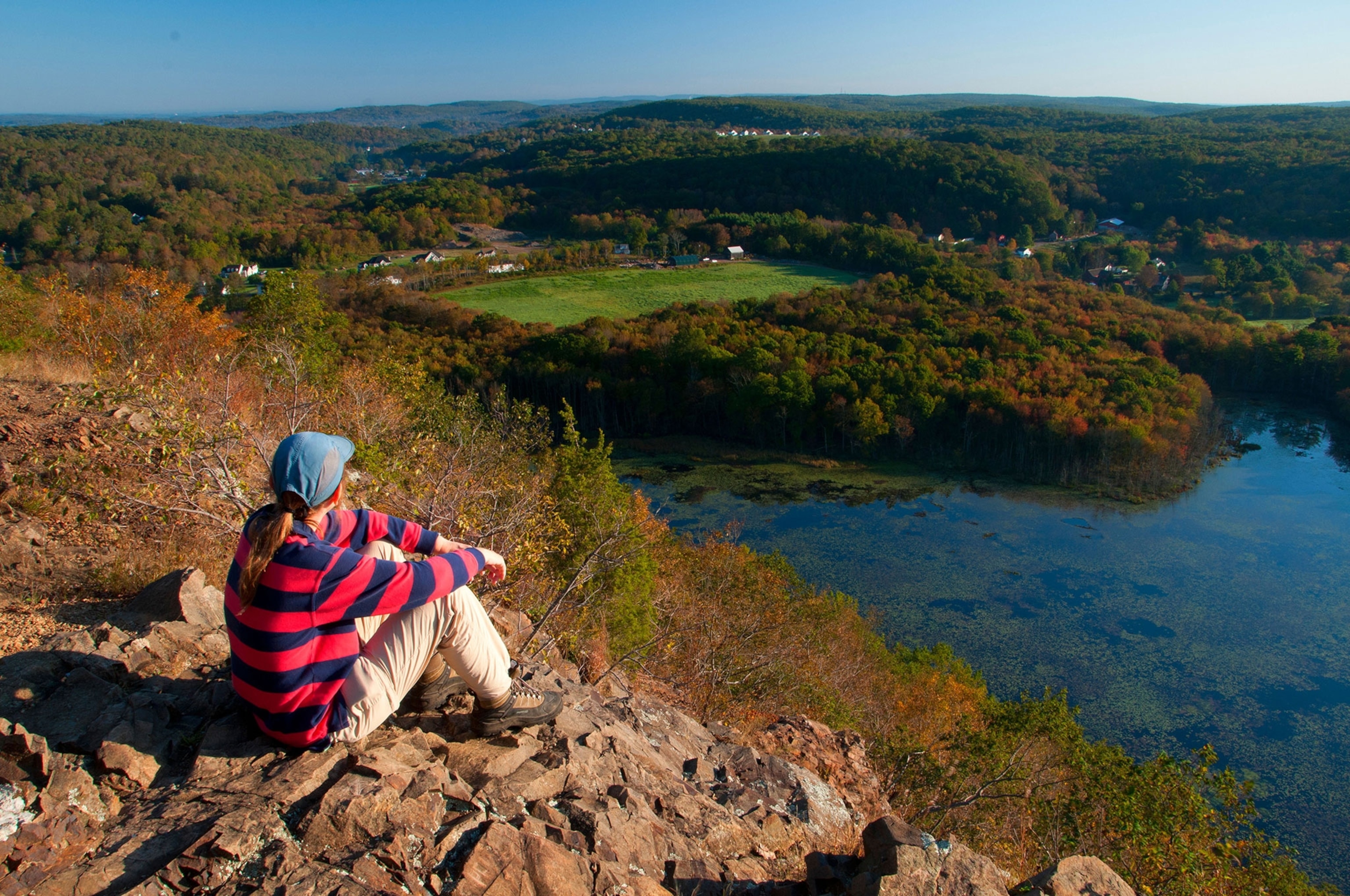 a hiker looking on Bluff Head ridge along Mattabesett Trail, Connecticut