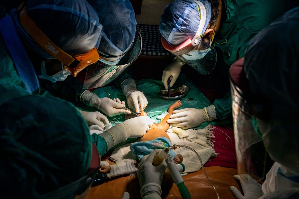 Doctors attend to a baby suffering from COVID-19.
