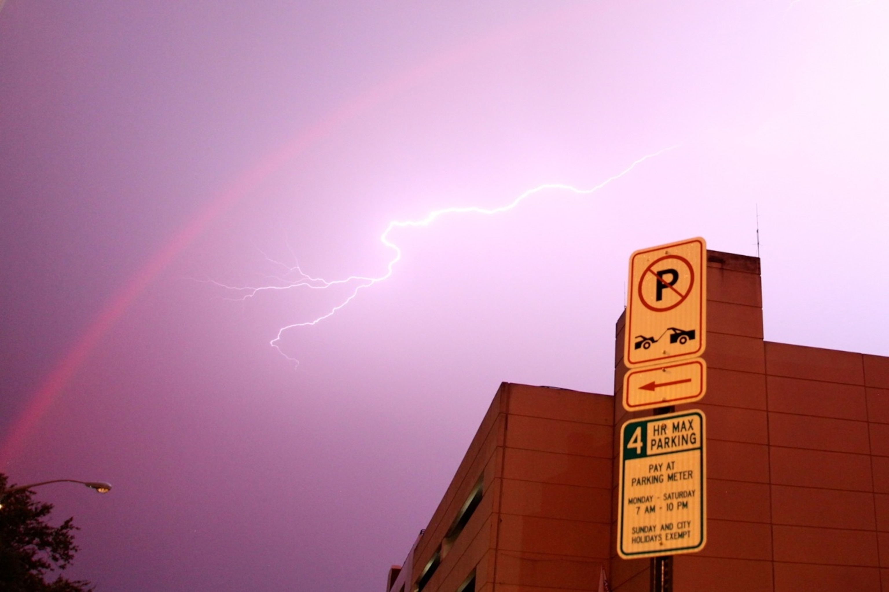Lightning bolts splinter across the lavender skies in downtown Atlanta, turning the nocturnal rainbow pink. (Photo by Andrew Evans, National Geographic Travel)