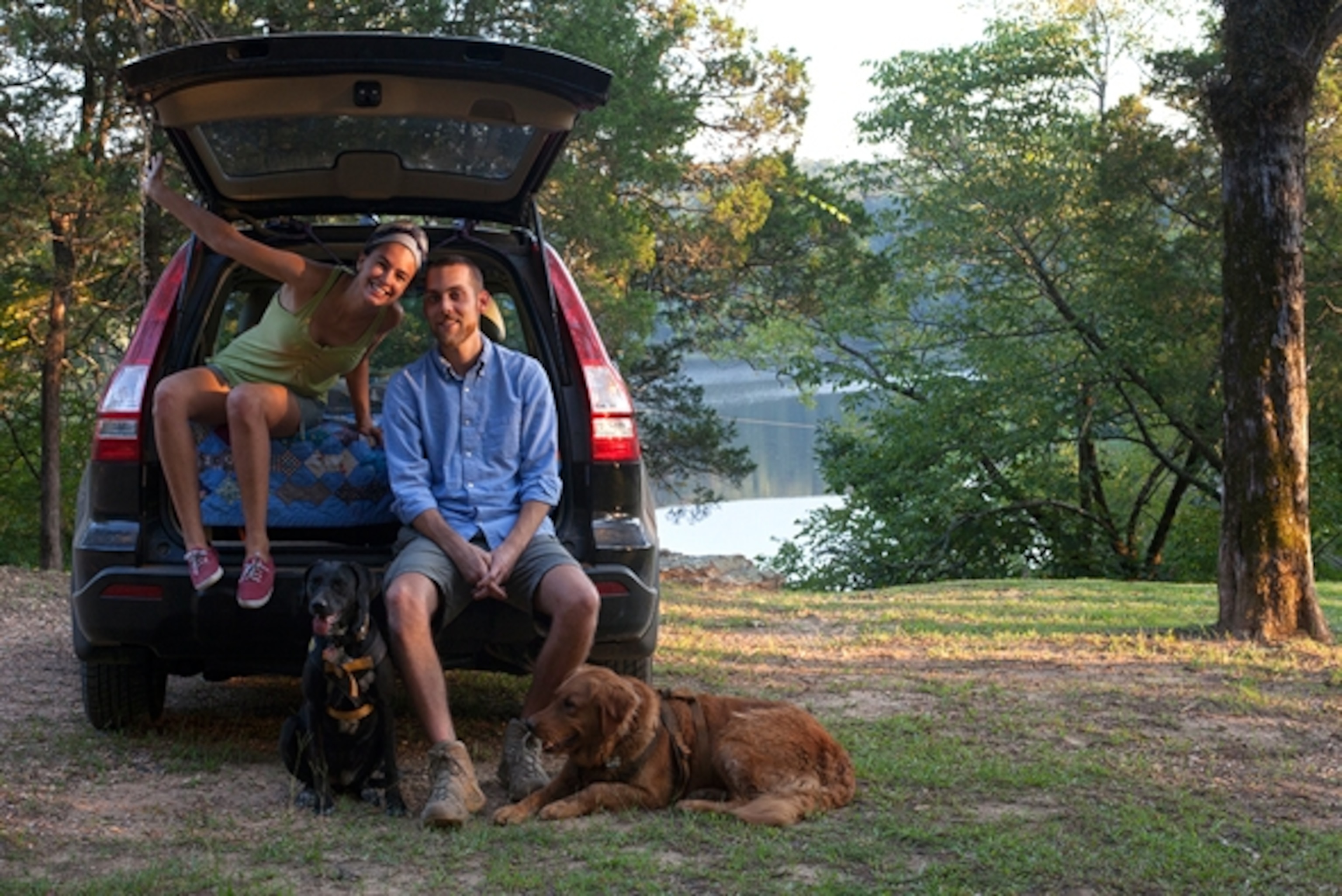 Annie Agnone, her partner and collaborator, Kevin, and their dogs pose by their car-turned-camper (Photograph by Annie Agnone)