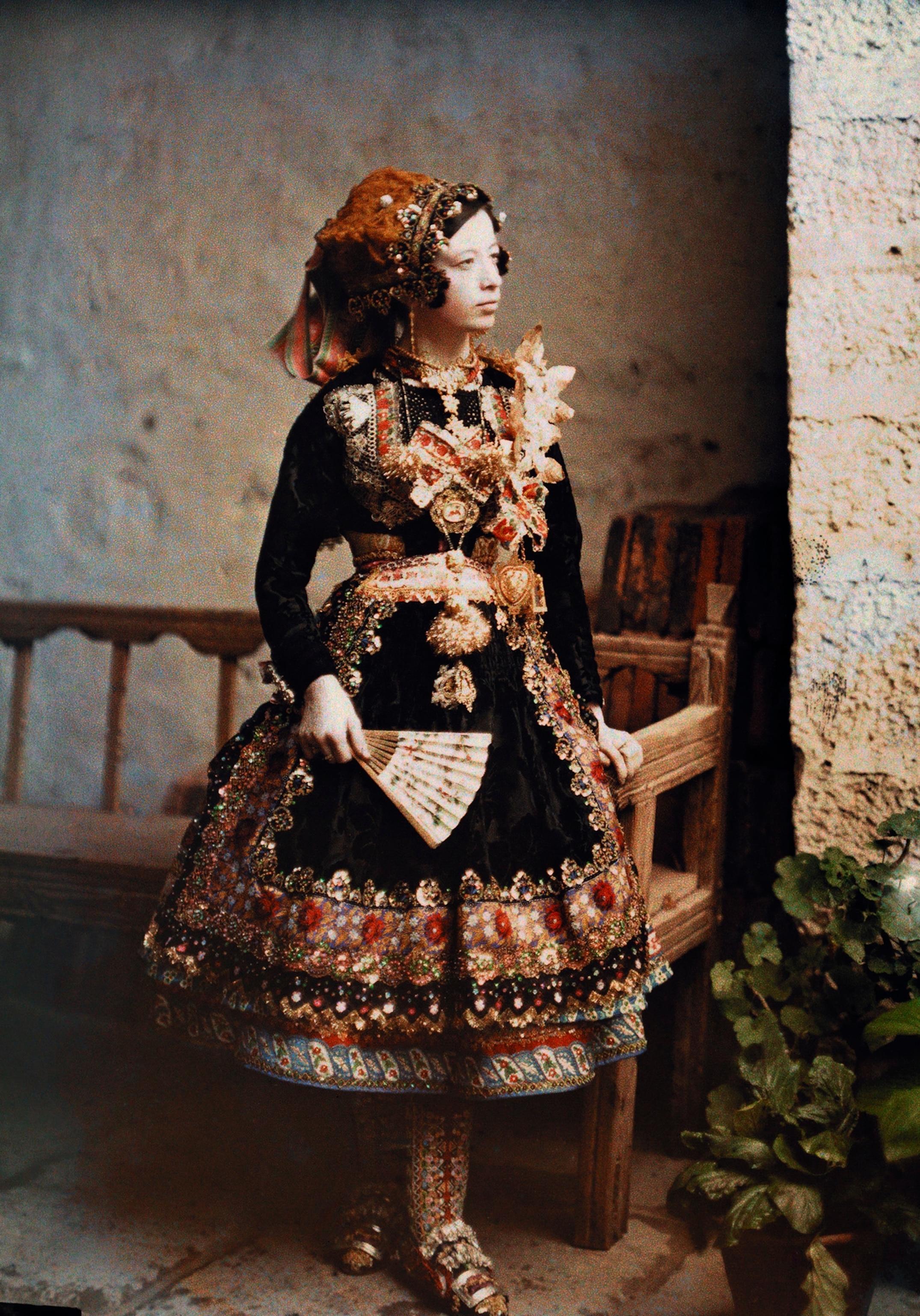 a girl poses in her traditional costume for an informal portrait in Lagartera, Spain.
