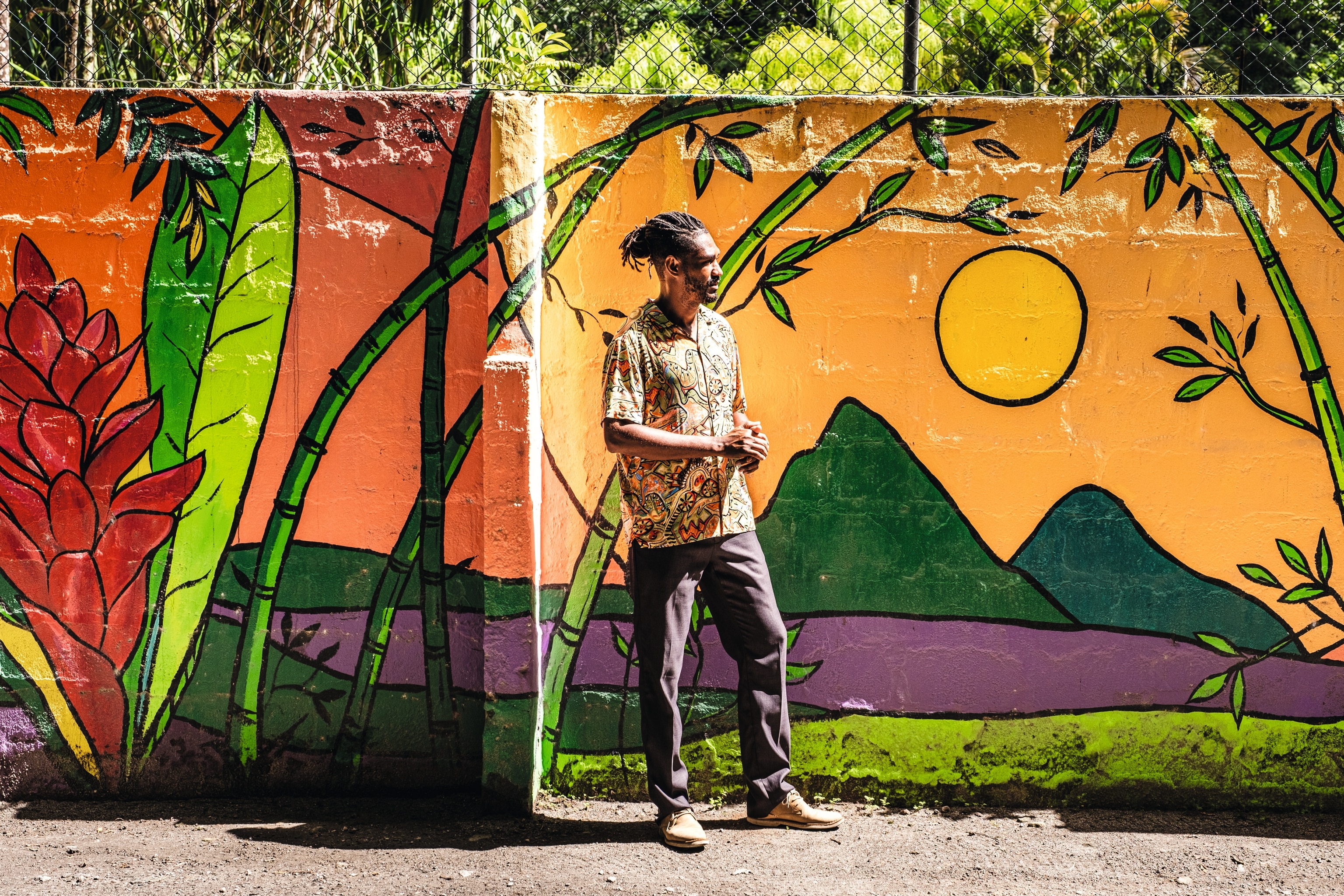 Man in front of a mural