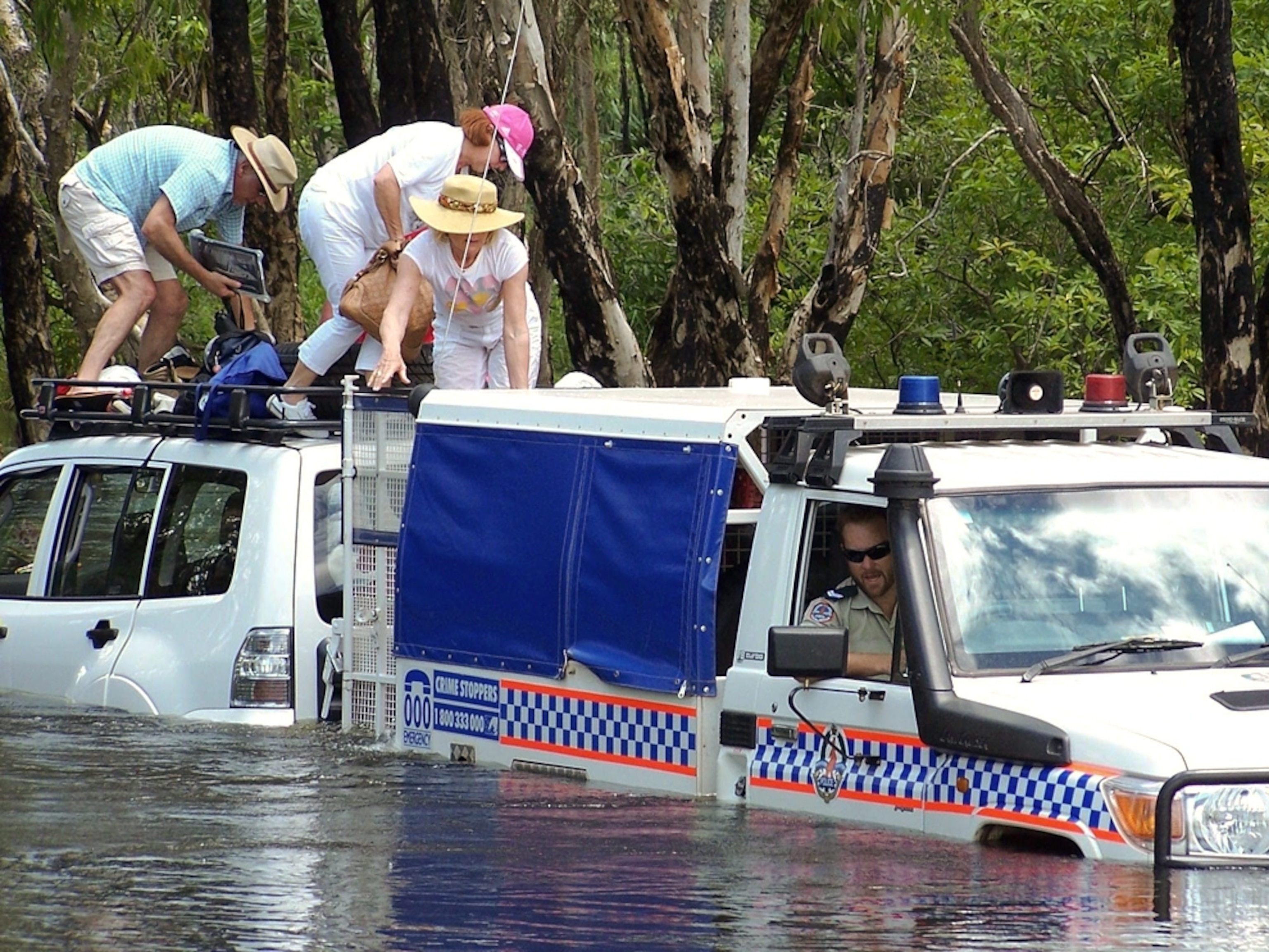 Tourists stranded in crocodile-infested waters are rescued by police