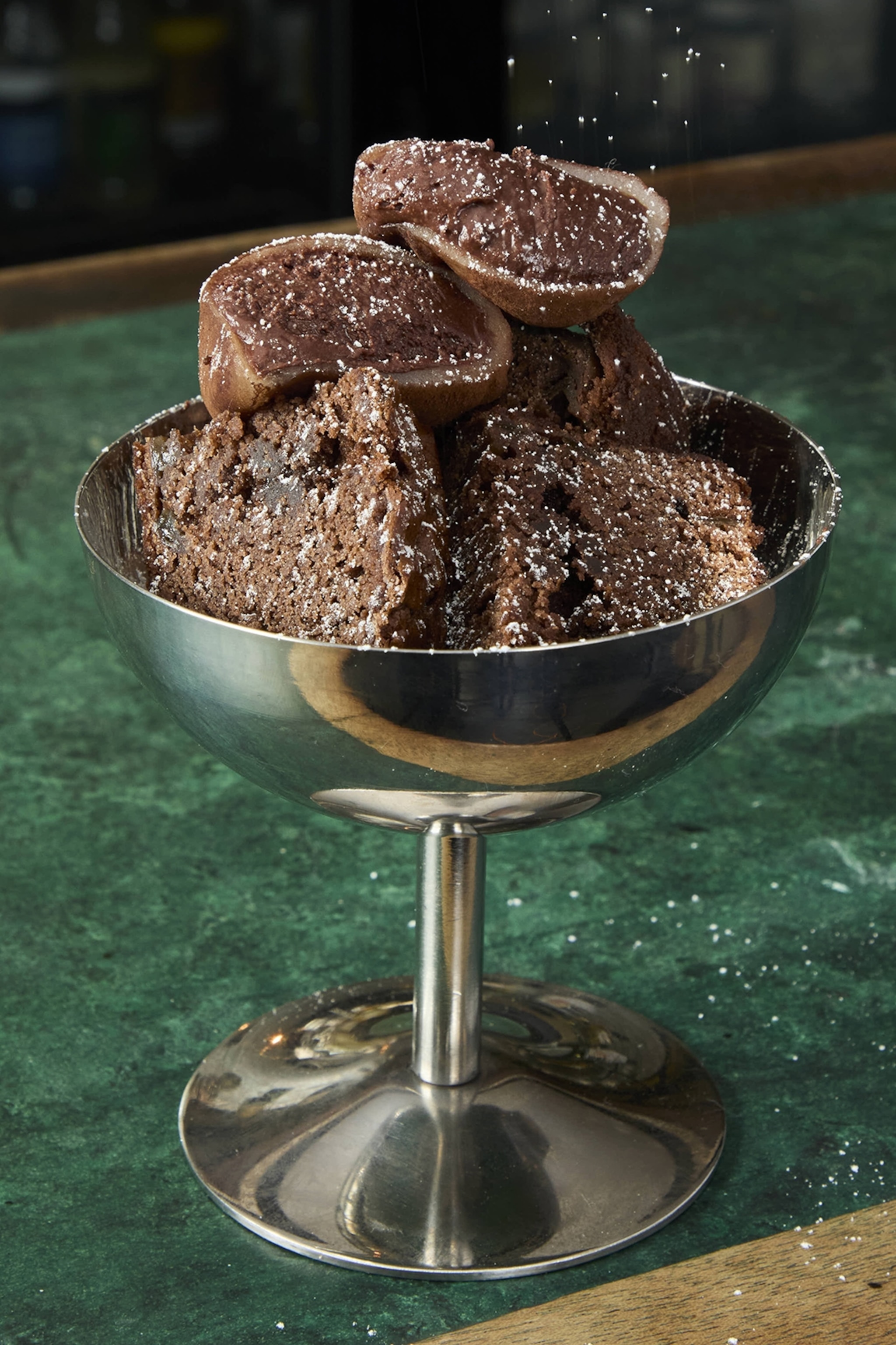 A cup of brownie bits topped with chocolate mochi.