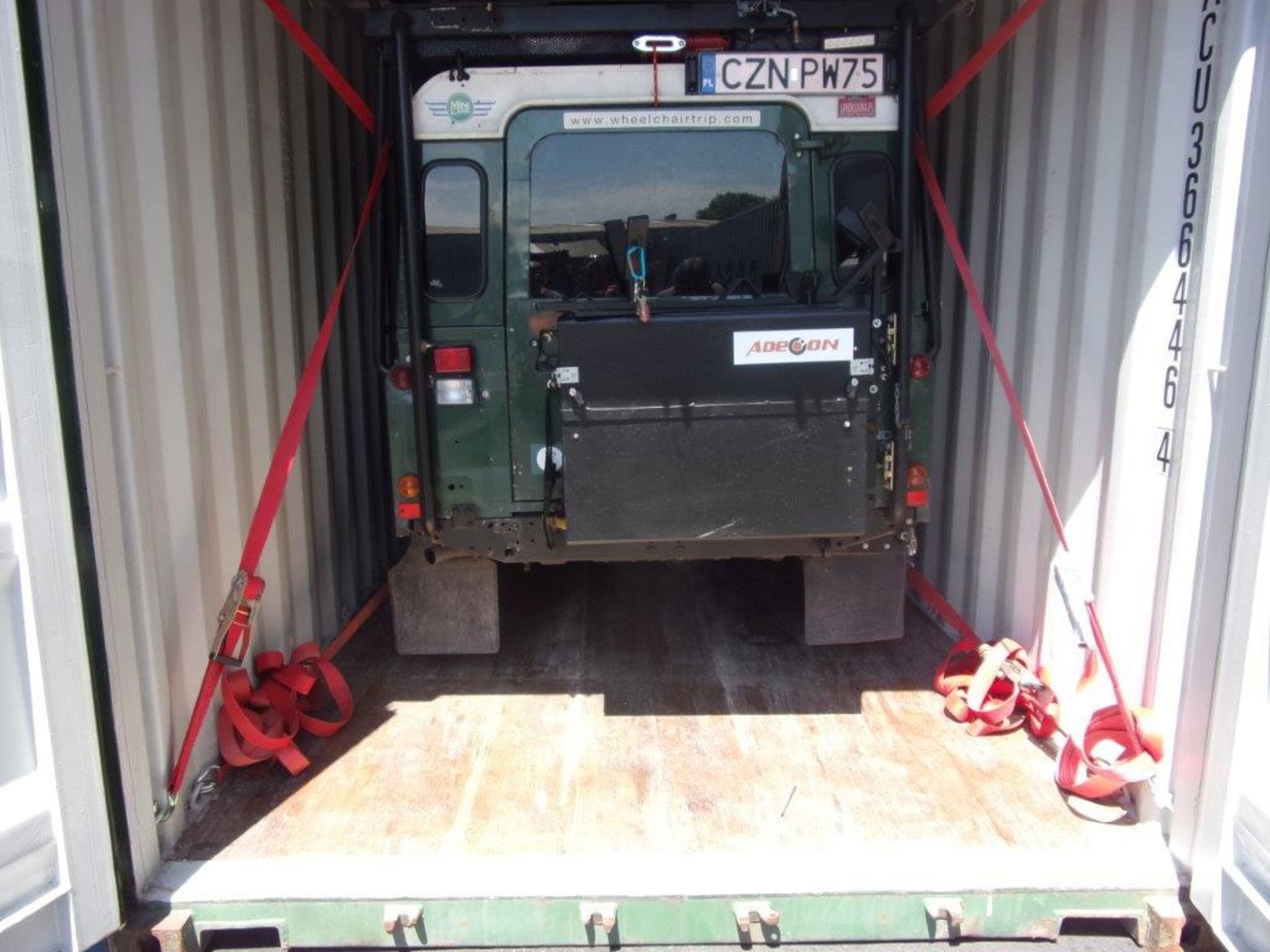 a Land Rover in a shipping container