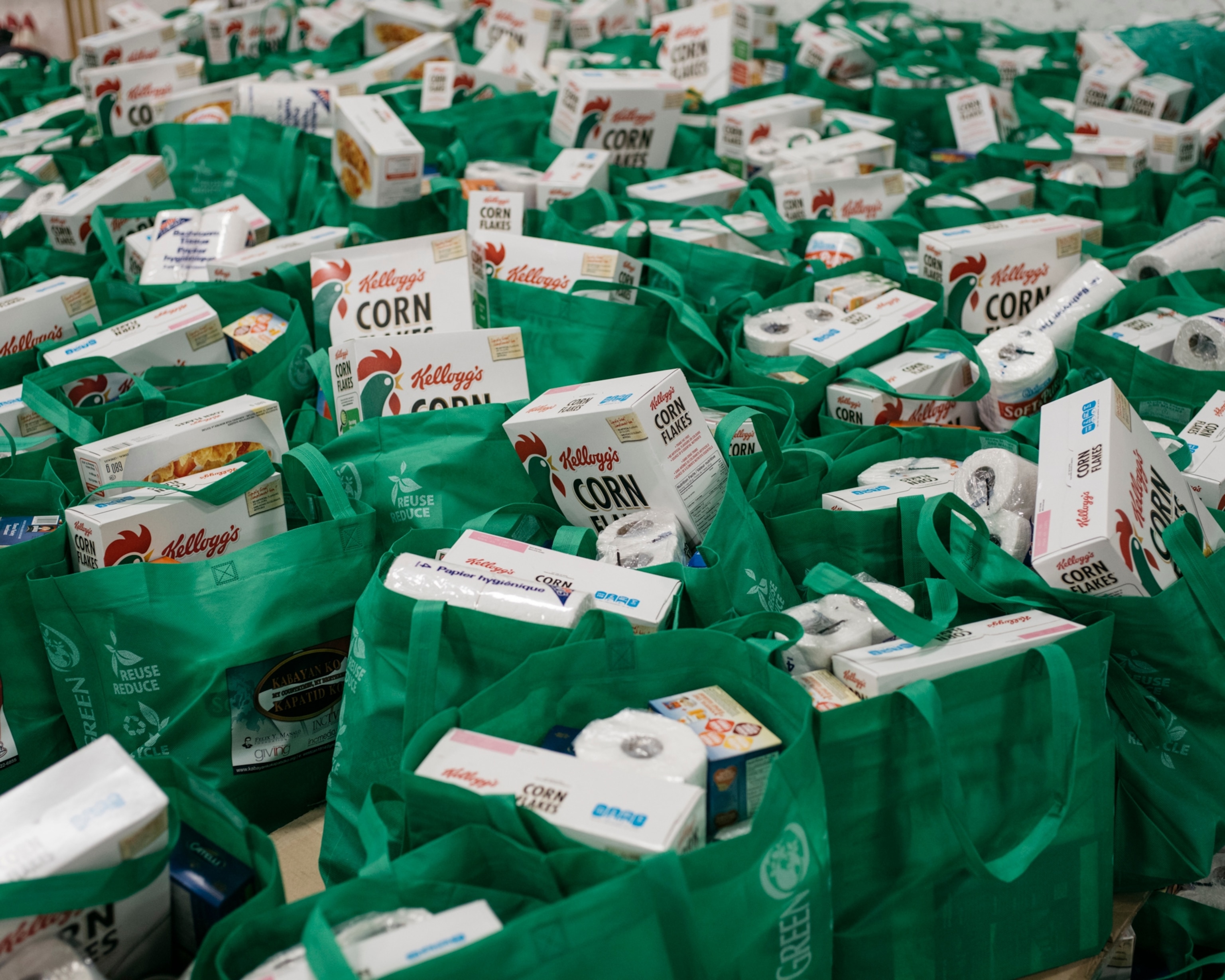 donated goods packed in green bags