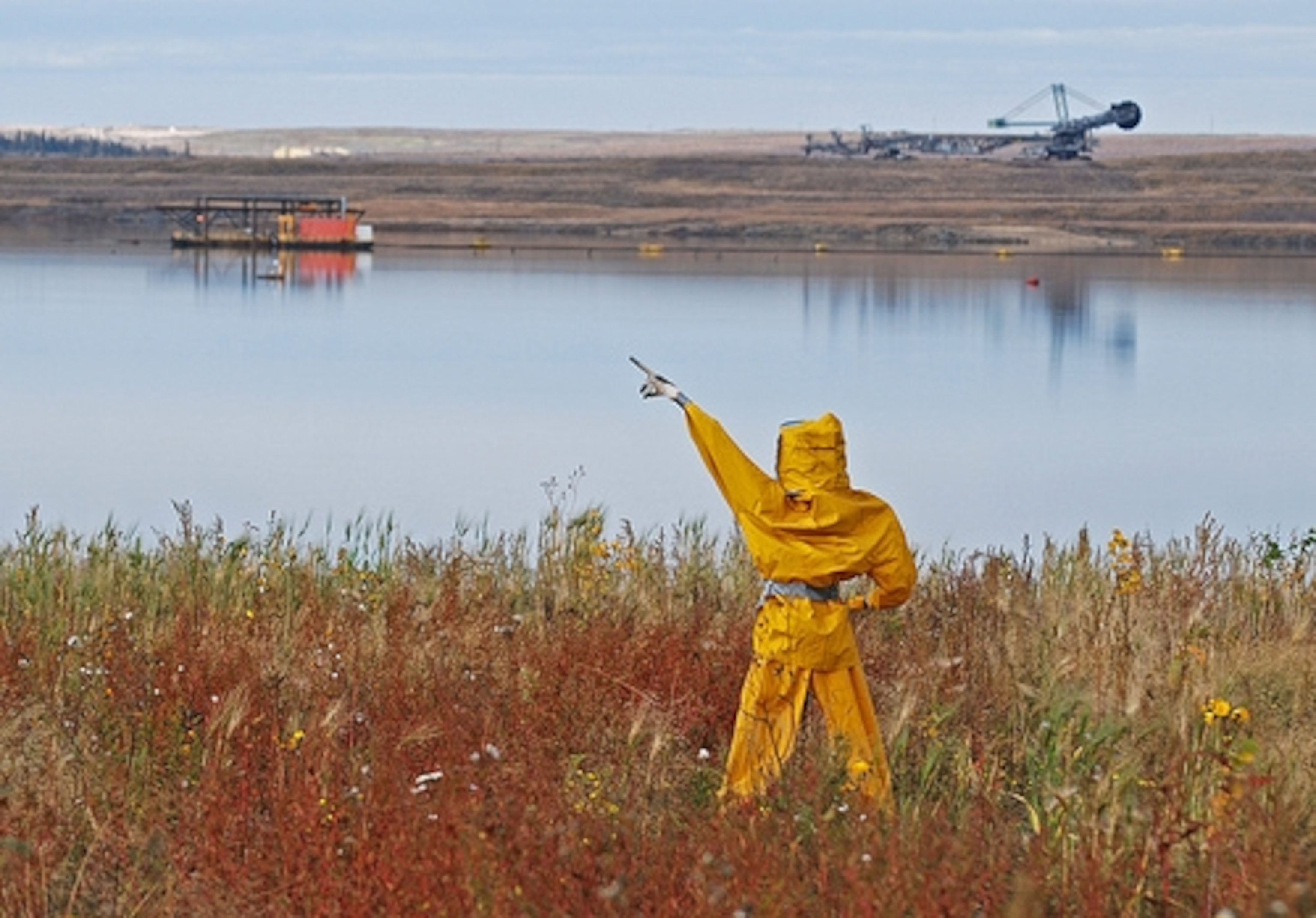 Scarecrows known as "bitchy-men" are set out to dissuade birds from landing on toxic tailings ponds. Photo by NWFblogs/Flickr.