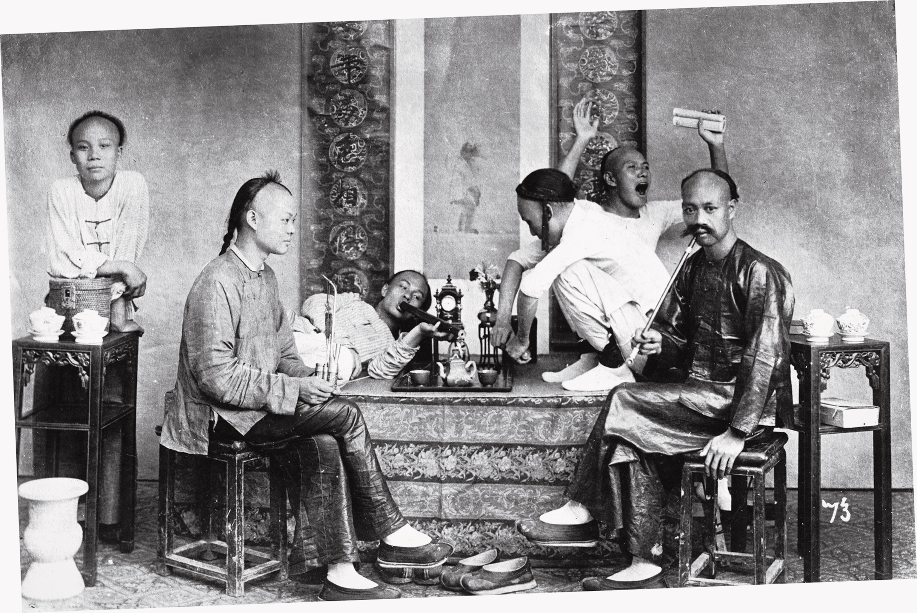 A postcard image of opium smokers, undoubtedly posed.