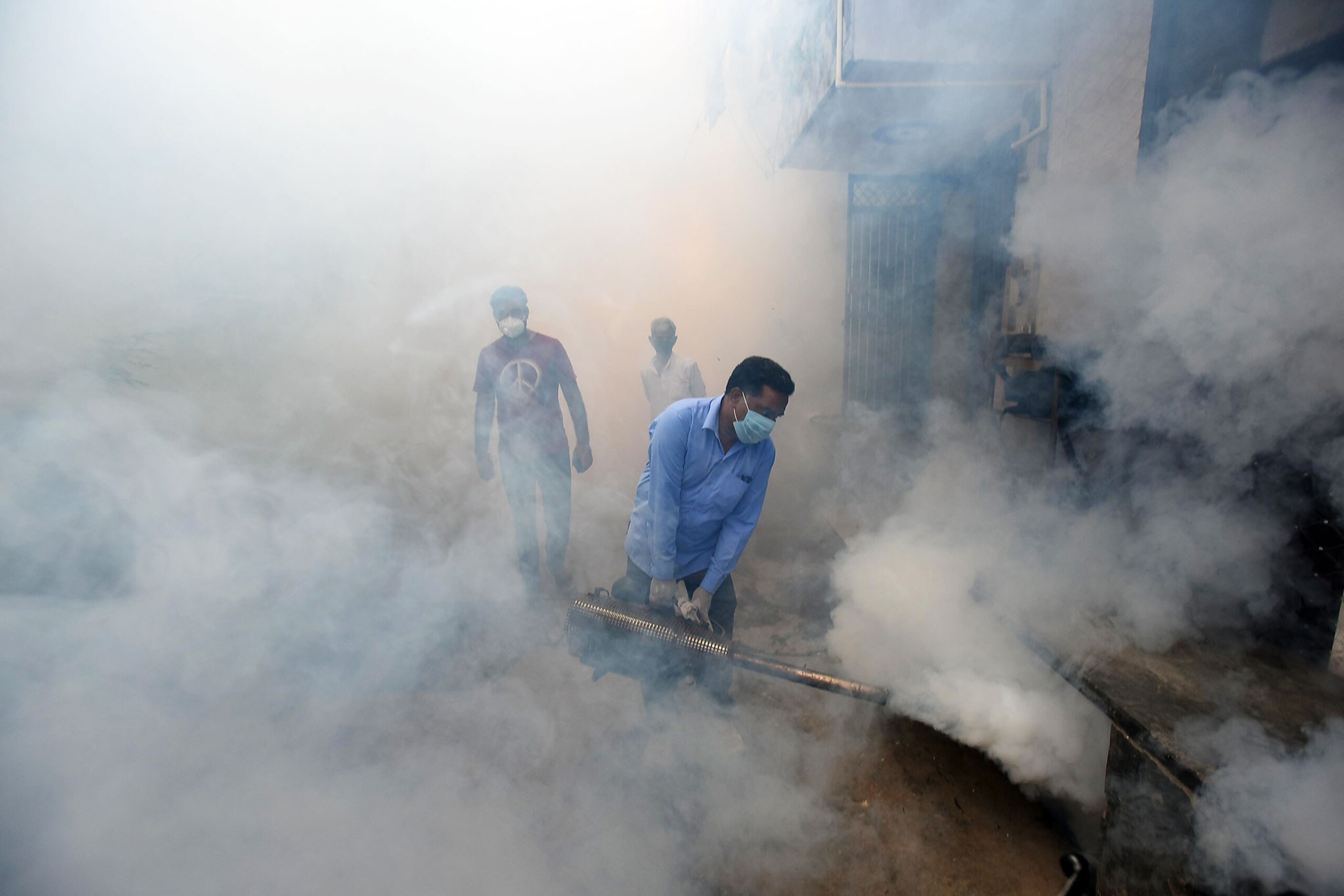 Workers fumigate in New Delhi, India, for mosquitoes,