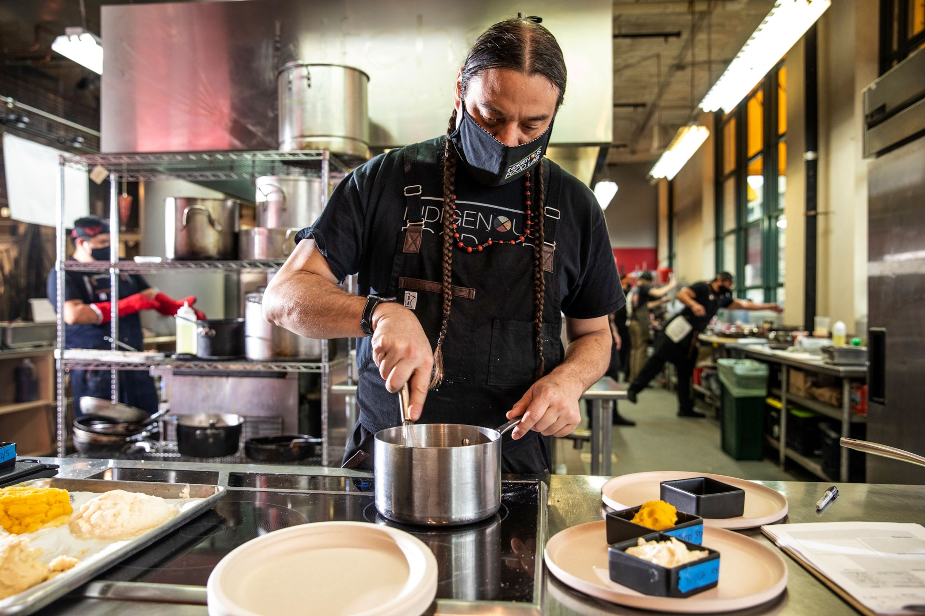 The Sioux Chef, Sean Sherman, prepares a recipe in his Minneapolis kitchen for the homeless.