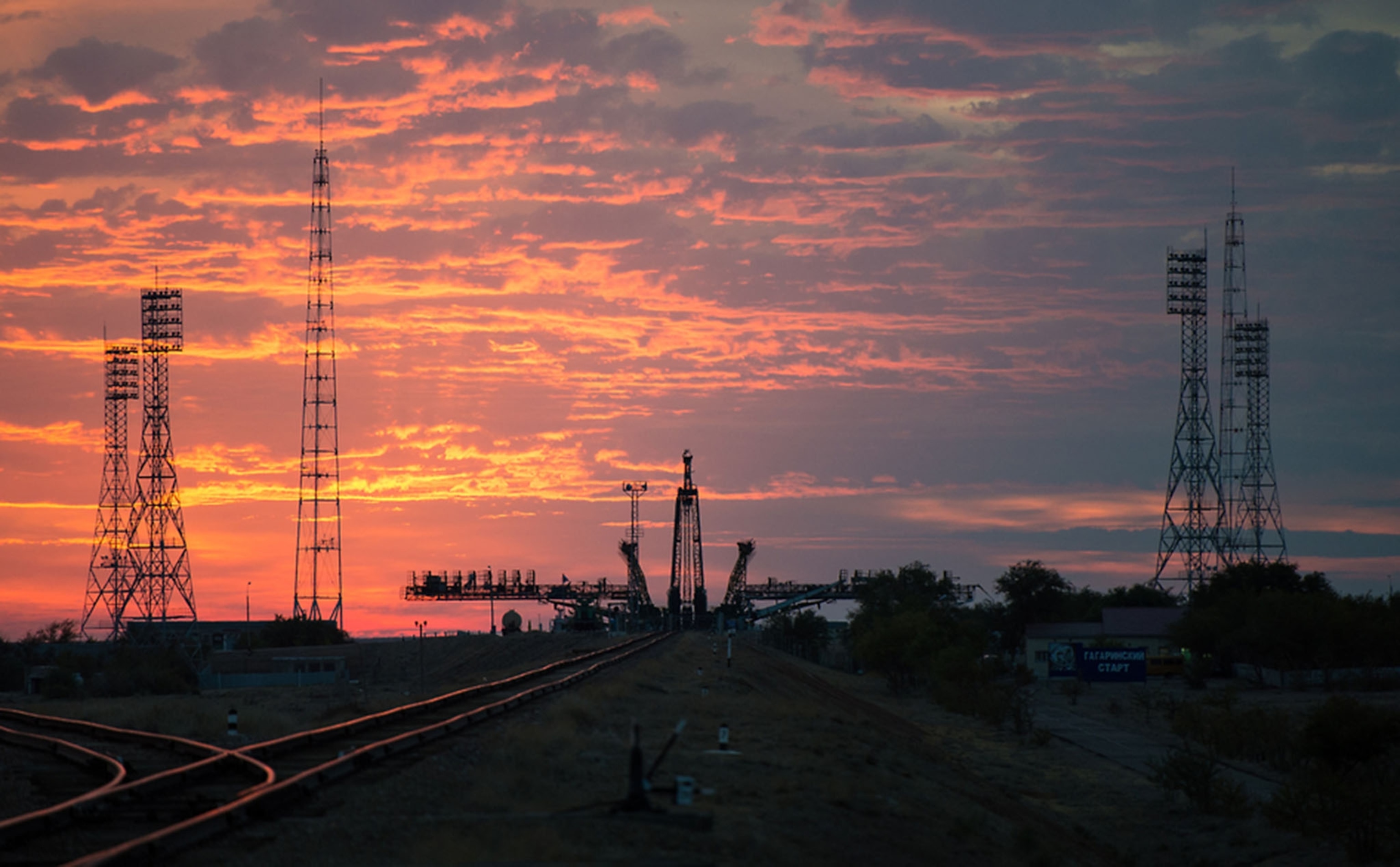 The sun rises behind the Soyuz launch pad as the Soyuz TMA-14M spacecraft is rolled out by train to the launch pad at the Baikonur Cosmodrome, Kazakhstan, Sept. 23, 2014.