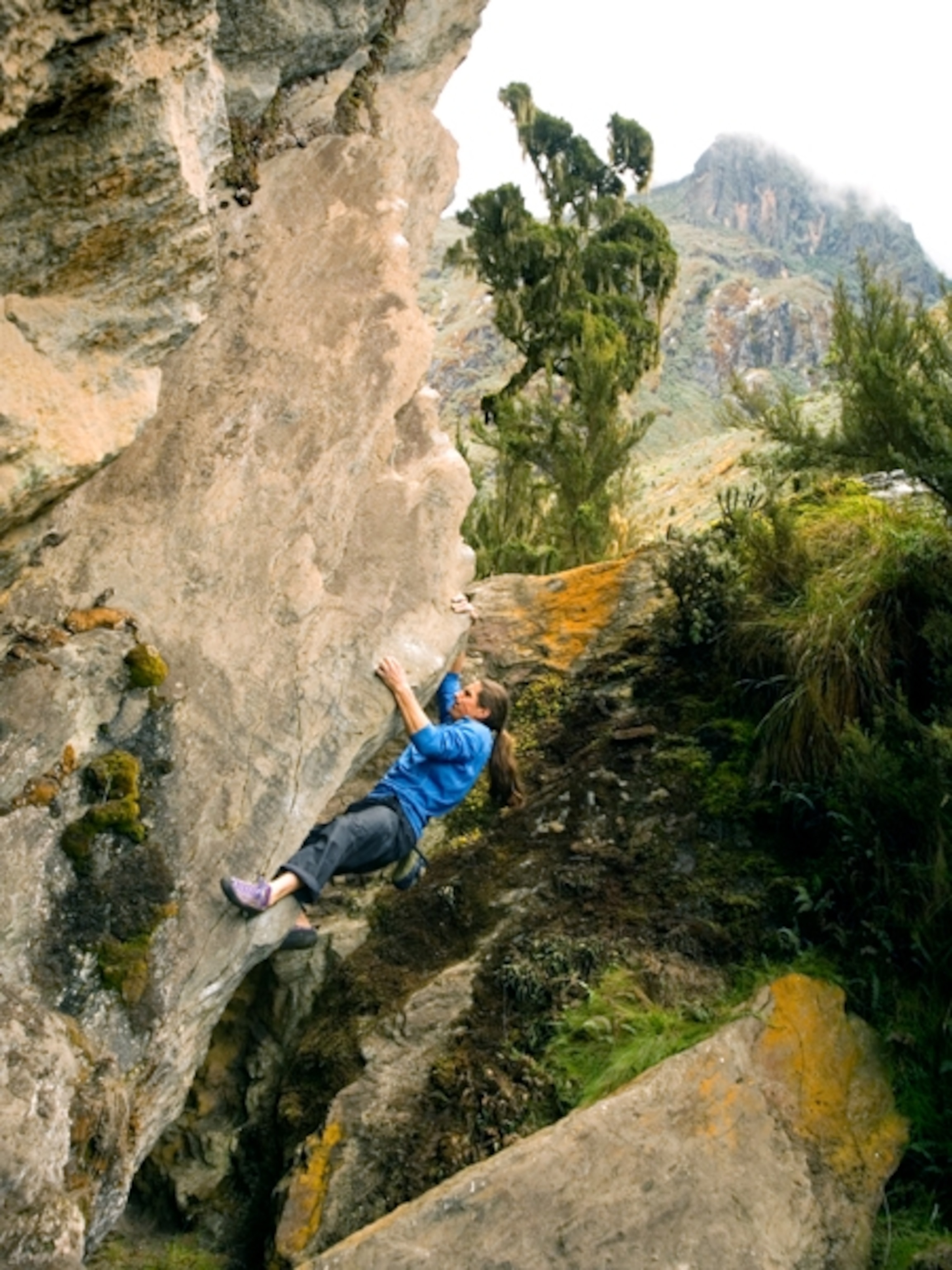Man rock climbs in the Rwenzori Mountains Uganda Africa