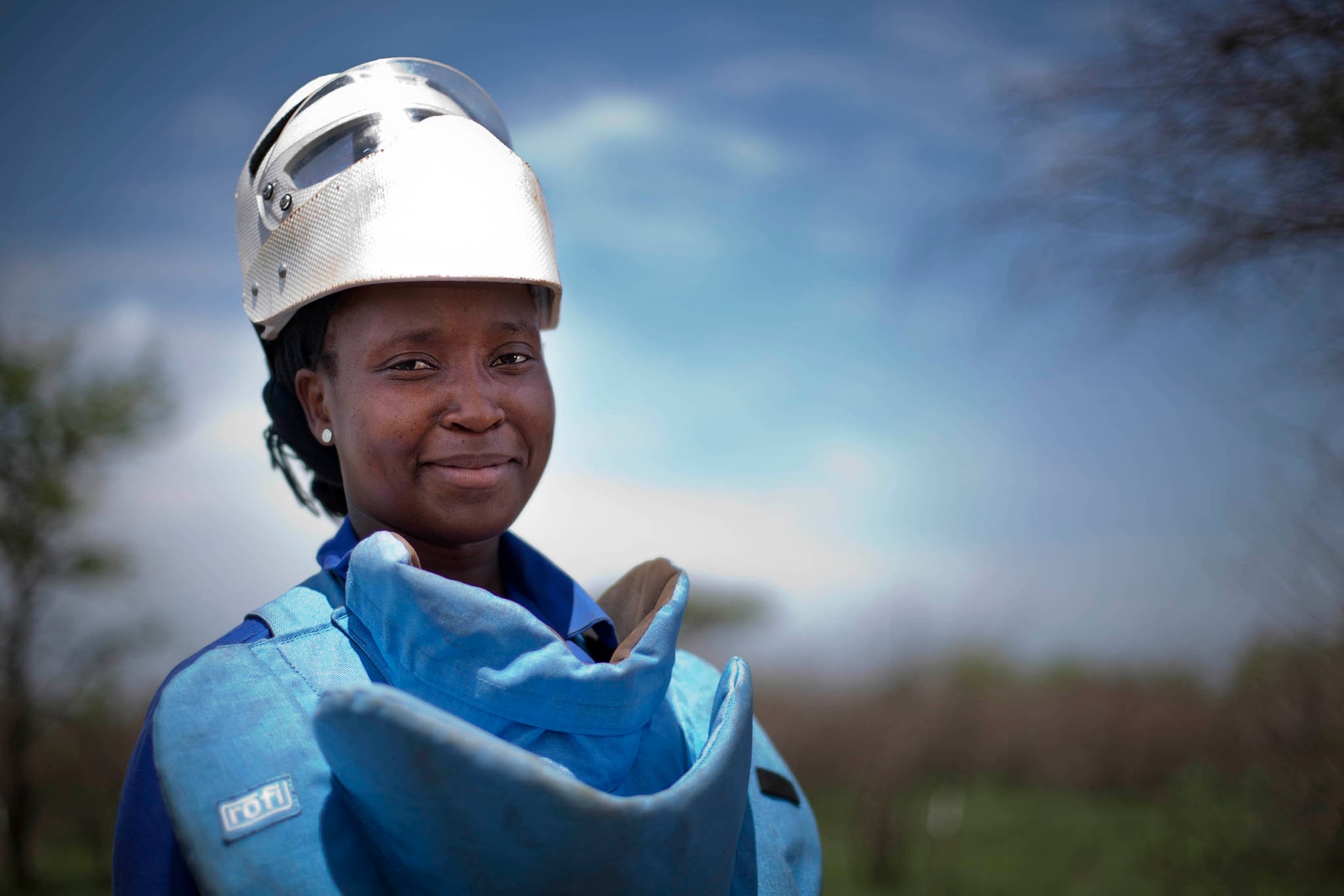 Flora Armando Chipossa Tenho uses a metal detector to search for land mines in southern Mozambique. Government forces placed mines around major infrastructure like these power lines to protect them from sabotage during the country’s long civil war.