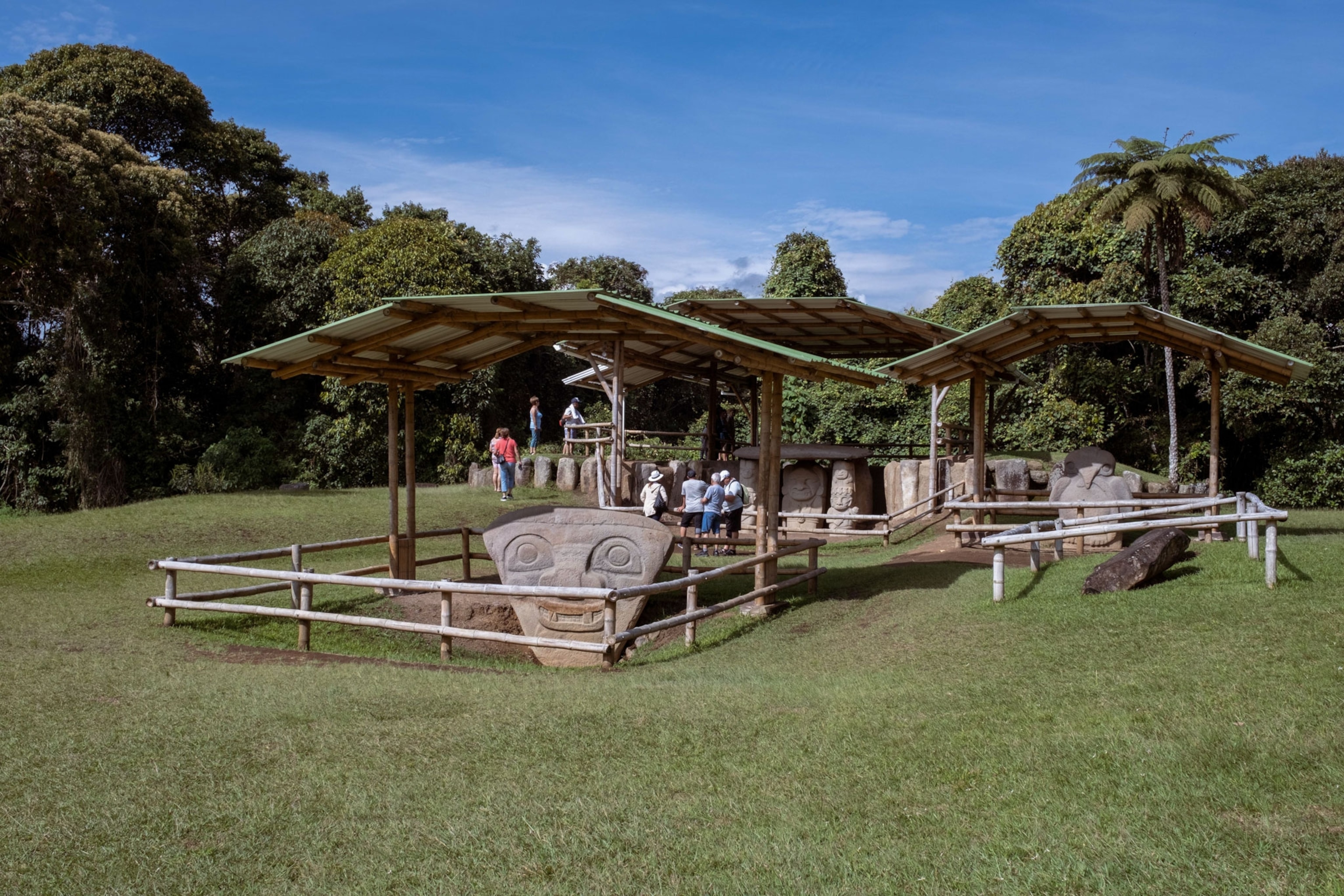 tourists looking at statues in San Agustin, Colombia