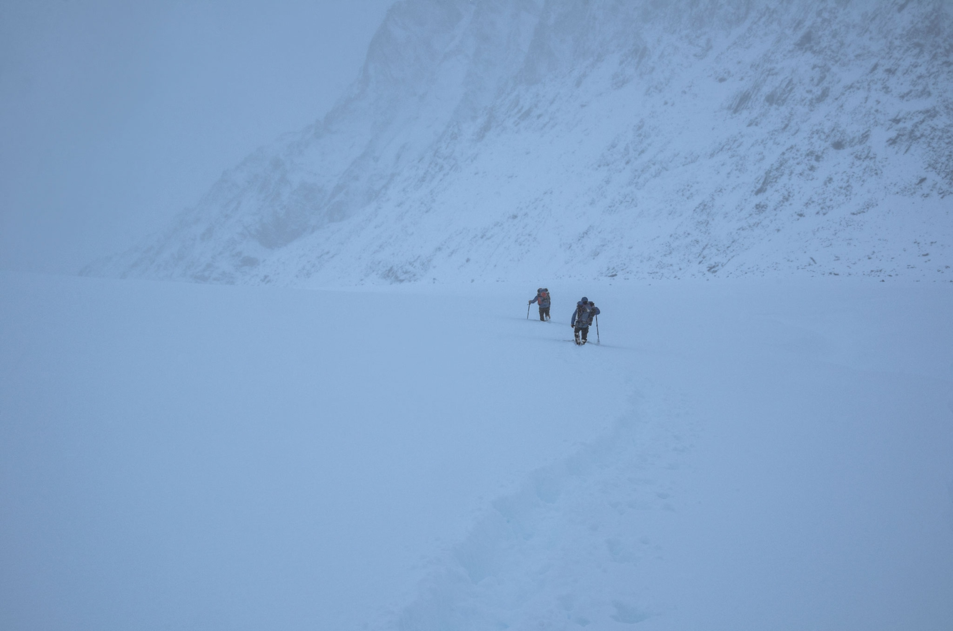climbers retreating in a snow storm down the Gangotri Glacier in the Indian Himalaya