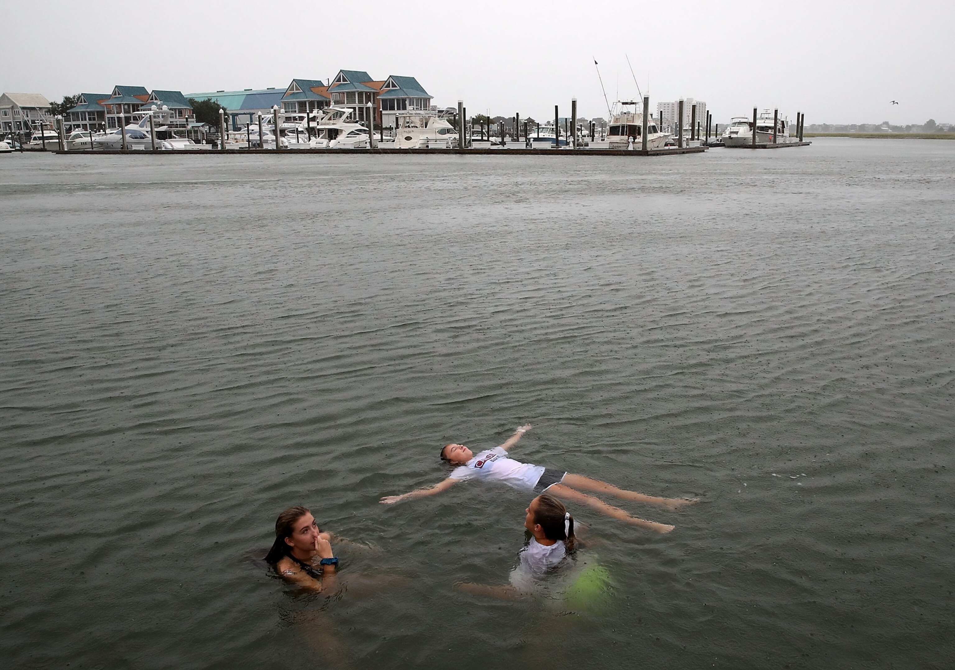 children swimming in the Intracoastal Waterway as Hurricane Florence approaches the are
