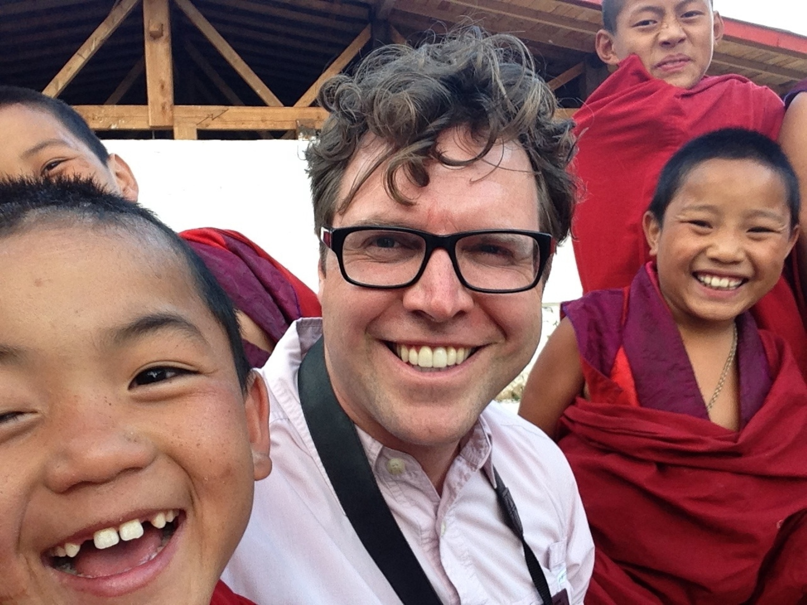 Sitting amongst a group of happy young monks at Dzong Rinpung in Paro, Bhutan. (Photo by Andrew Evans, National Geographic)