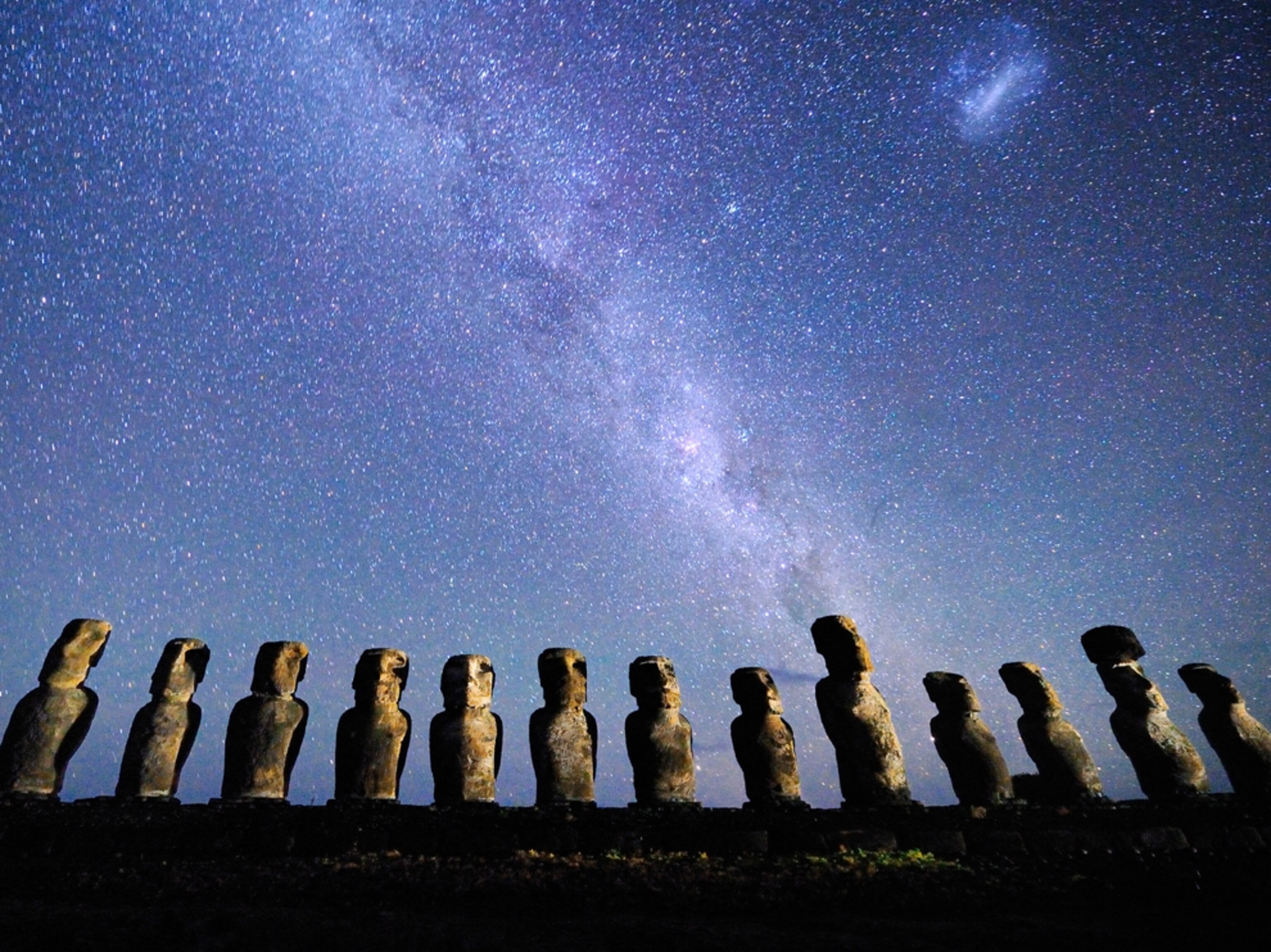 Stone statues under starry sky