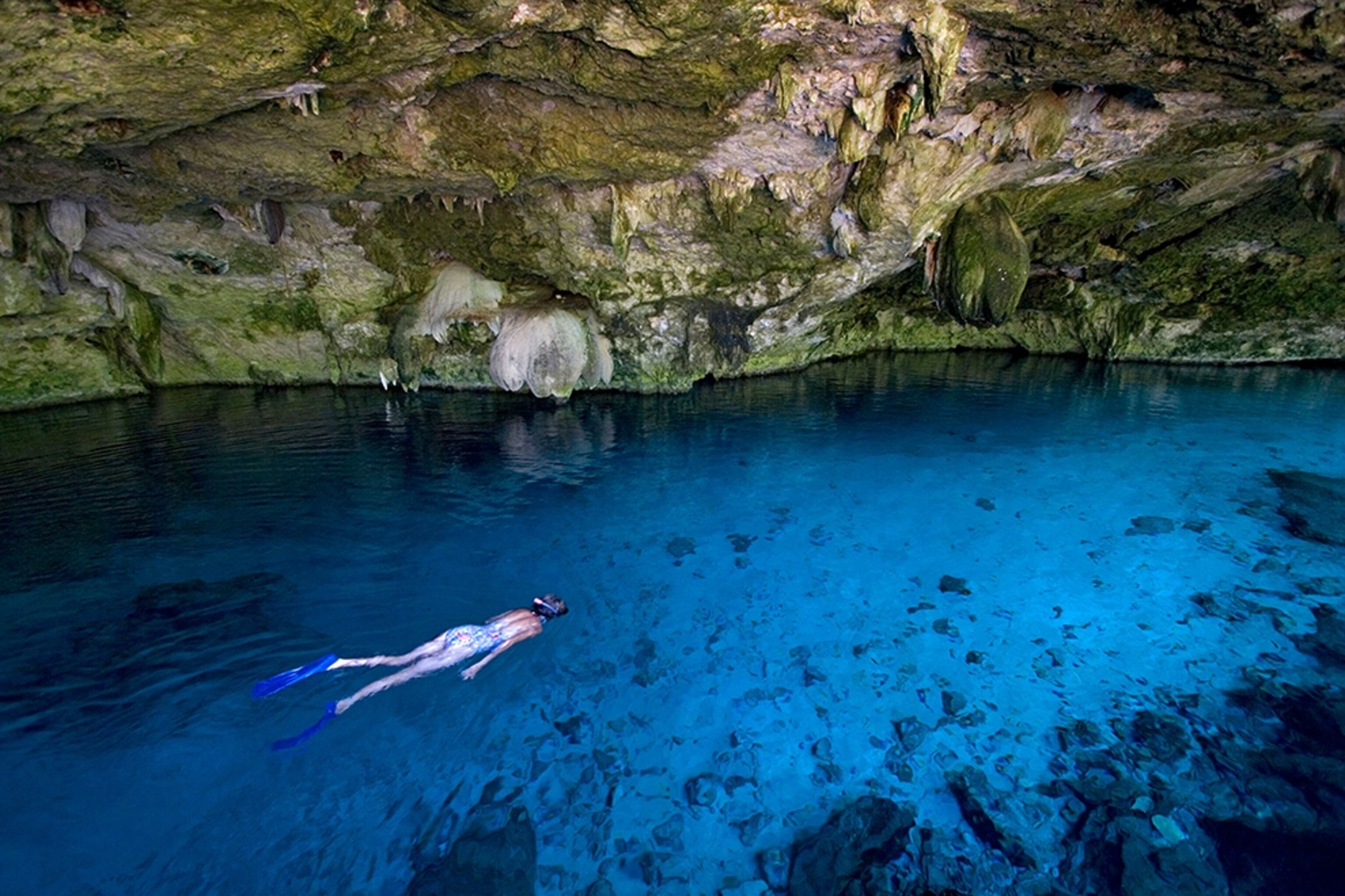 a lady snorkeling in the Two Eyes cenote, Yucatan Peninsula, Mexico