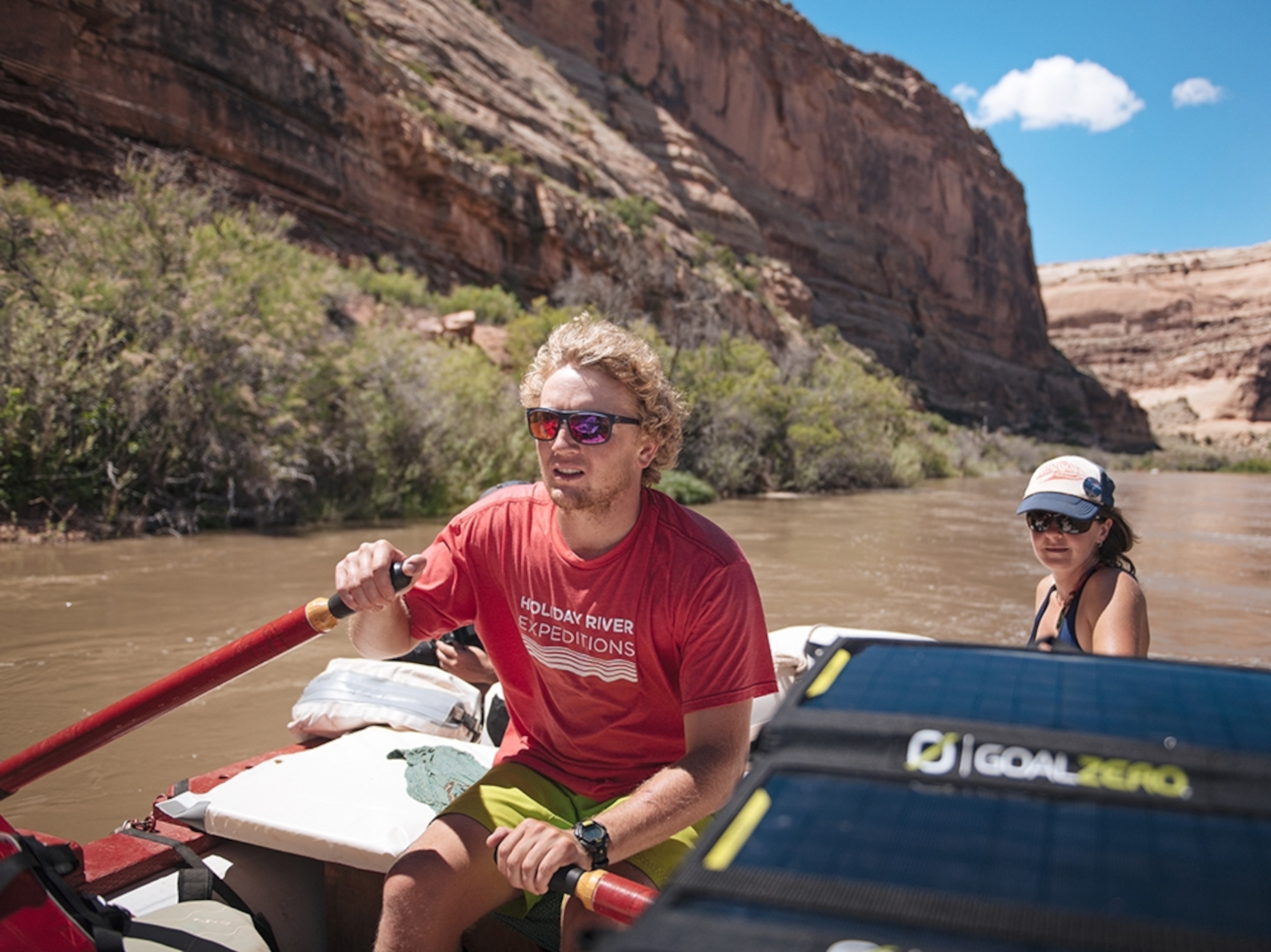 a white water boat guide looking down a river while floating in Utah.