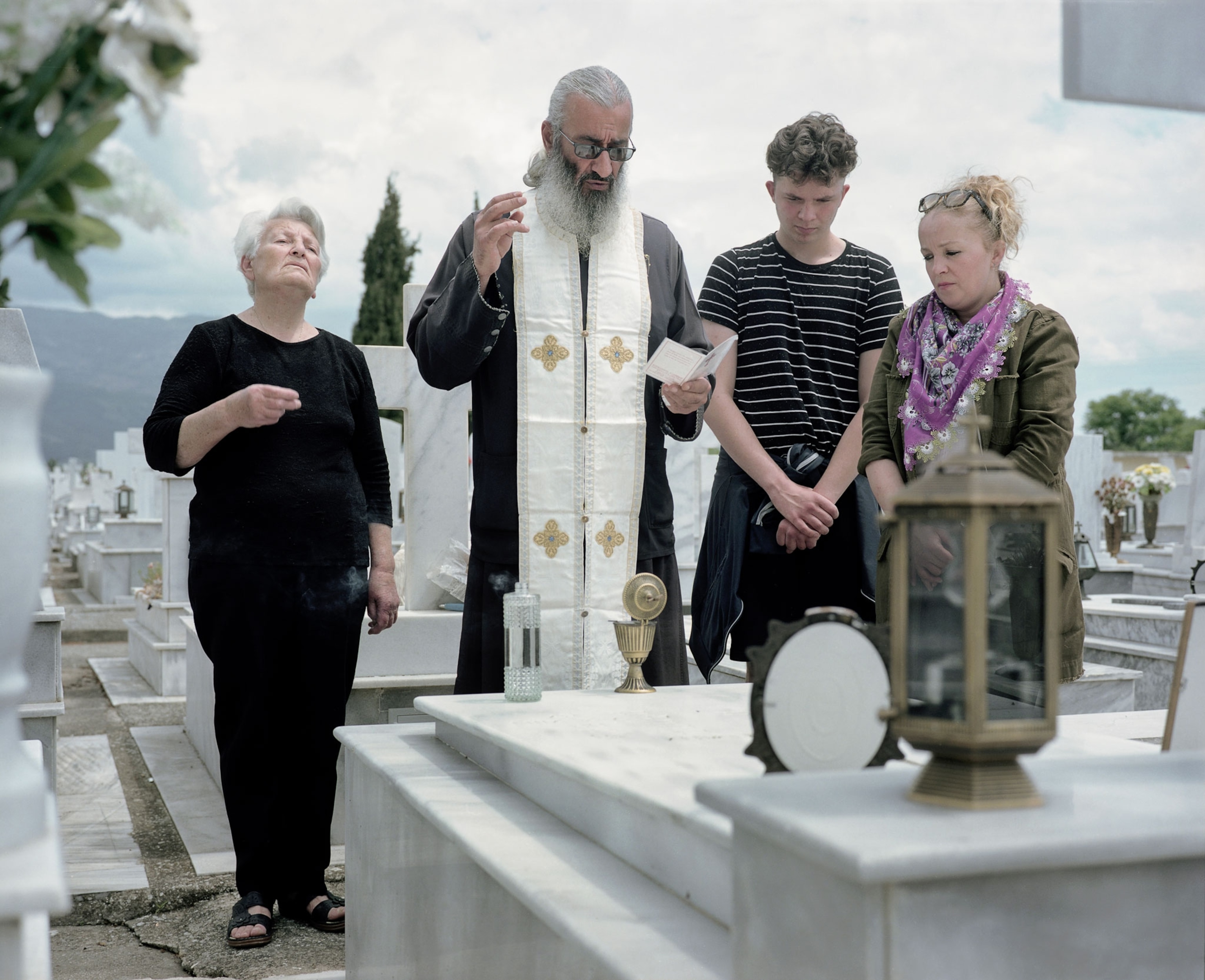 a Pomak people praying in a graveyard