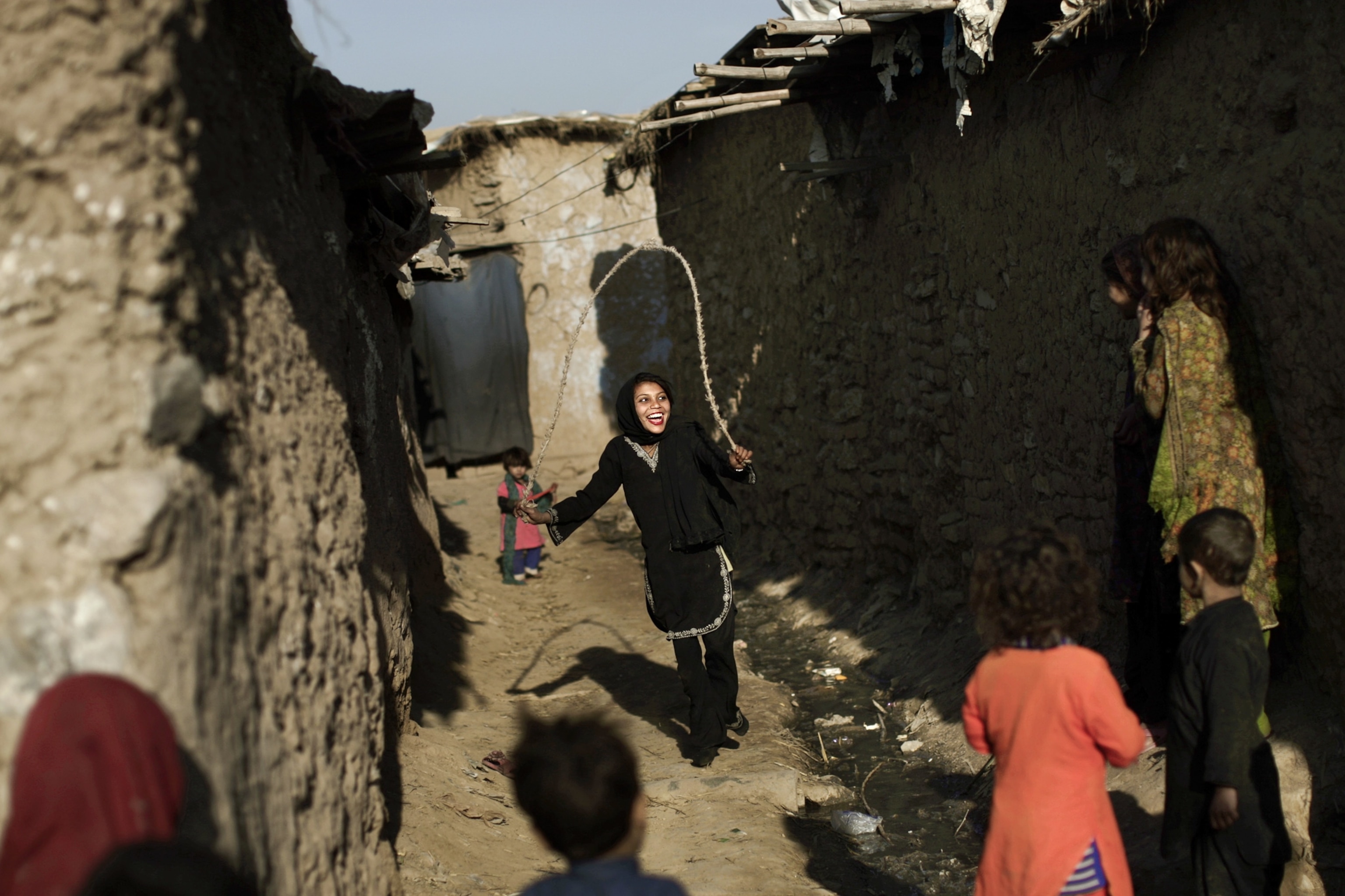 a girl skipping rope in an alley on the outskirts of Islamabad, Pakistan