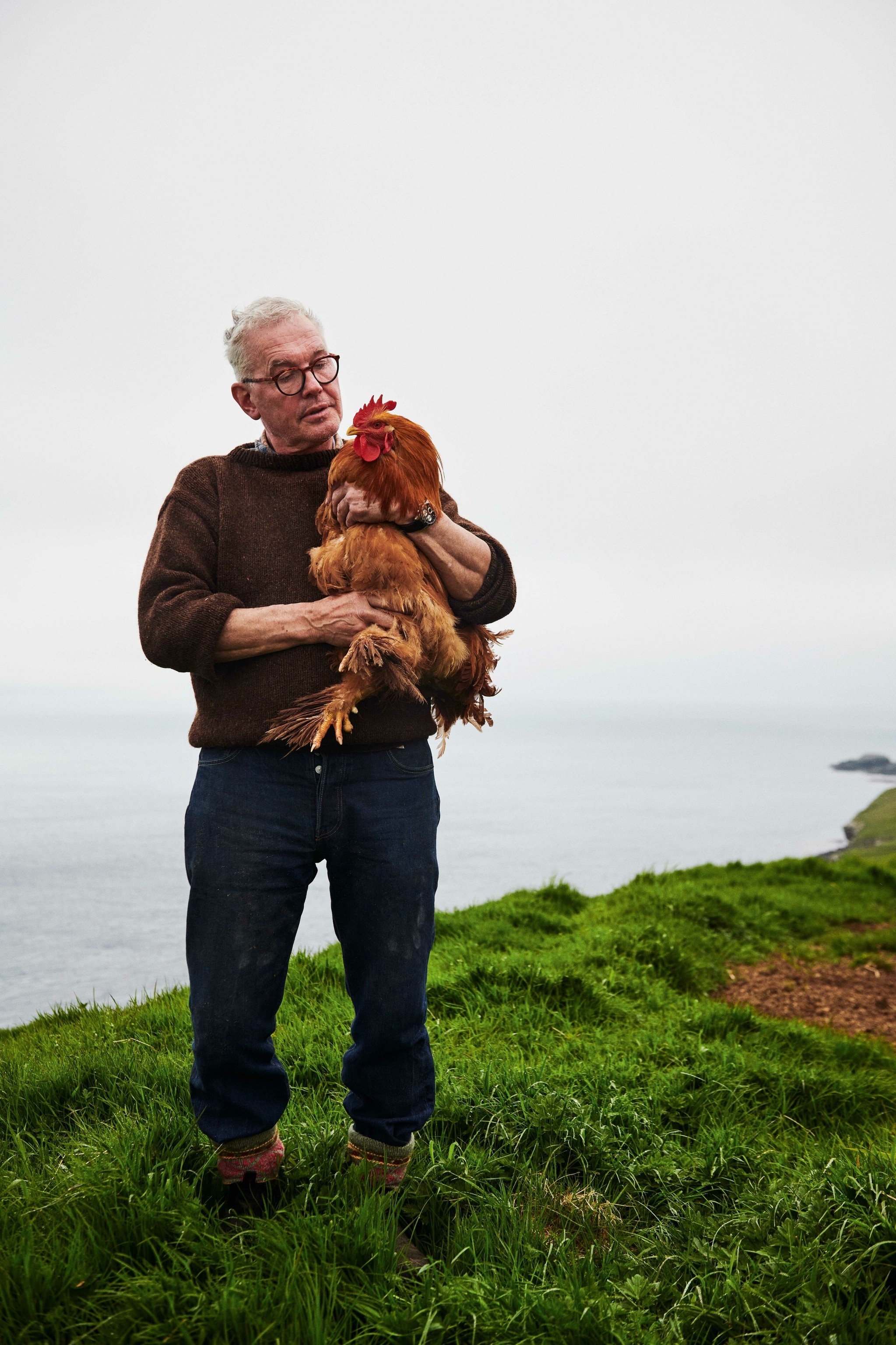 Óli with one of the couple’s chickens.