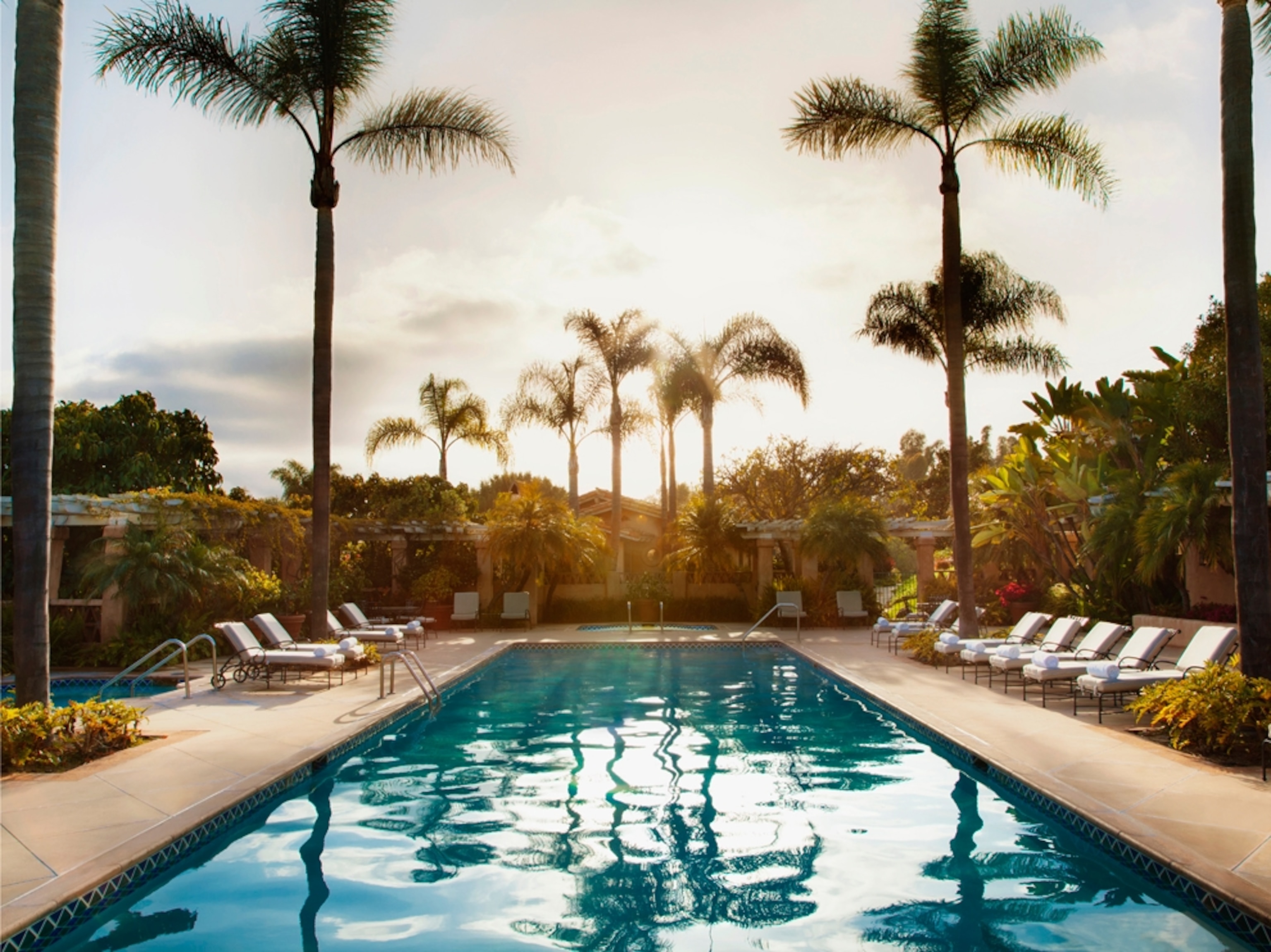 lounge chairs by a hotel swimming pool