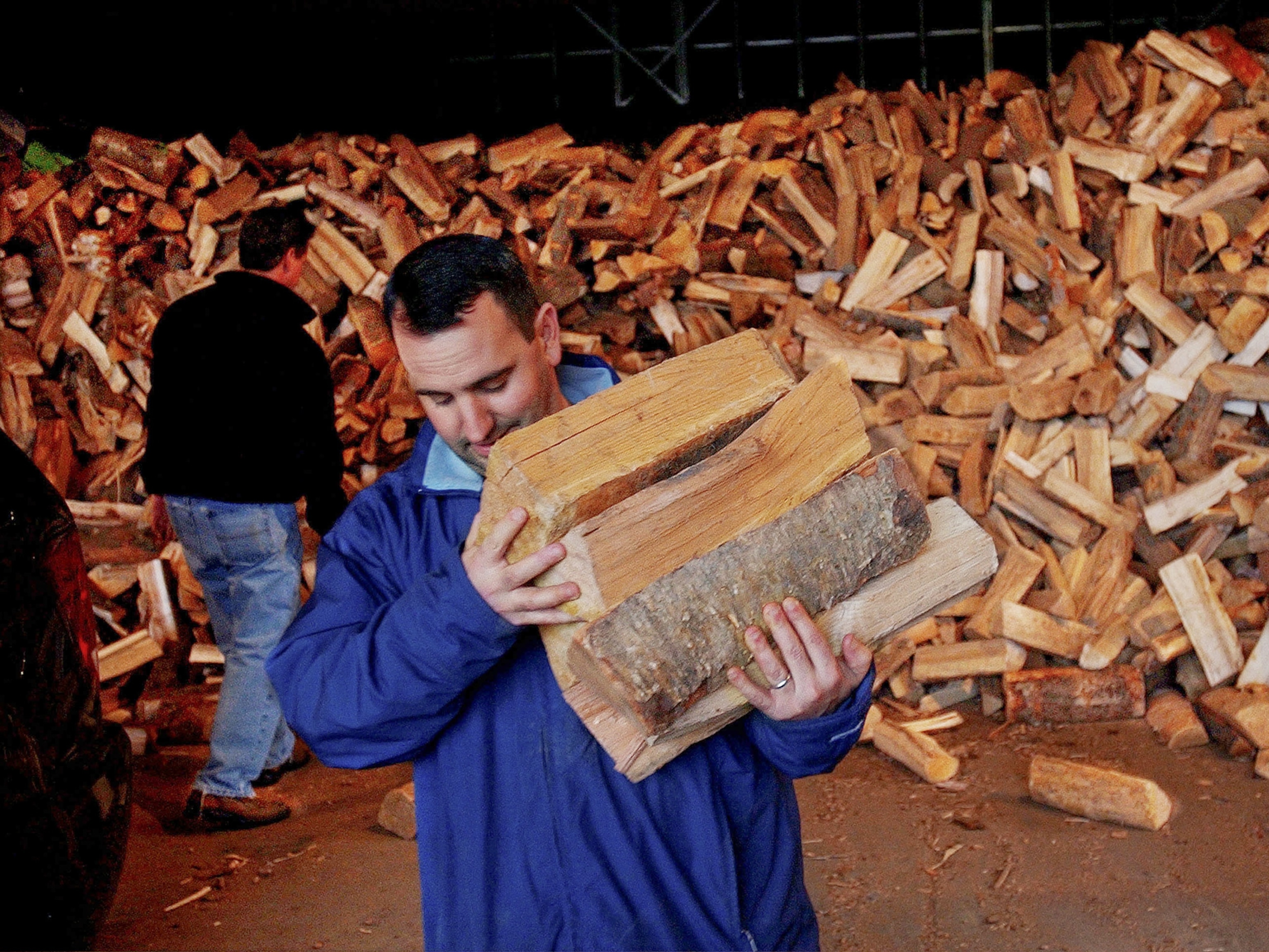 Firewood picture - a resident carries firewood to his car in Milton, Massachusetts.