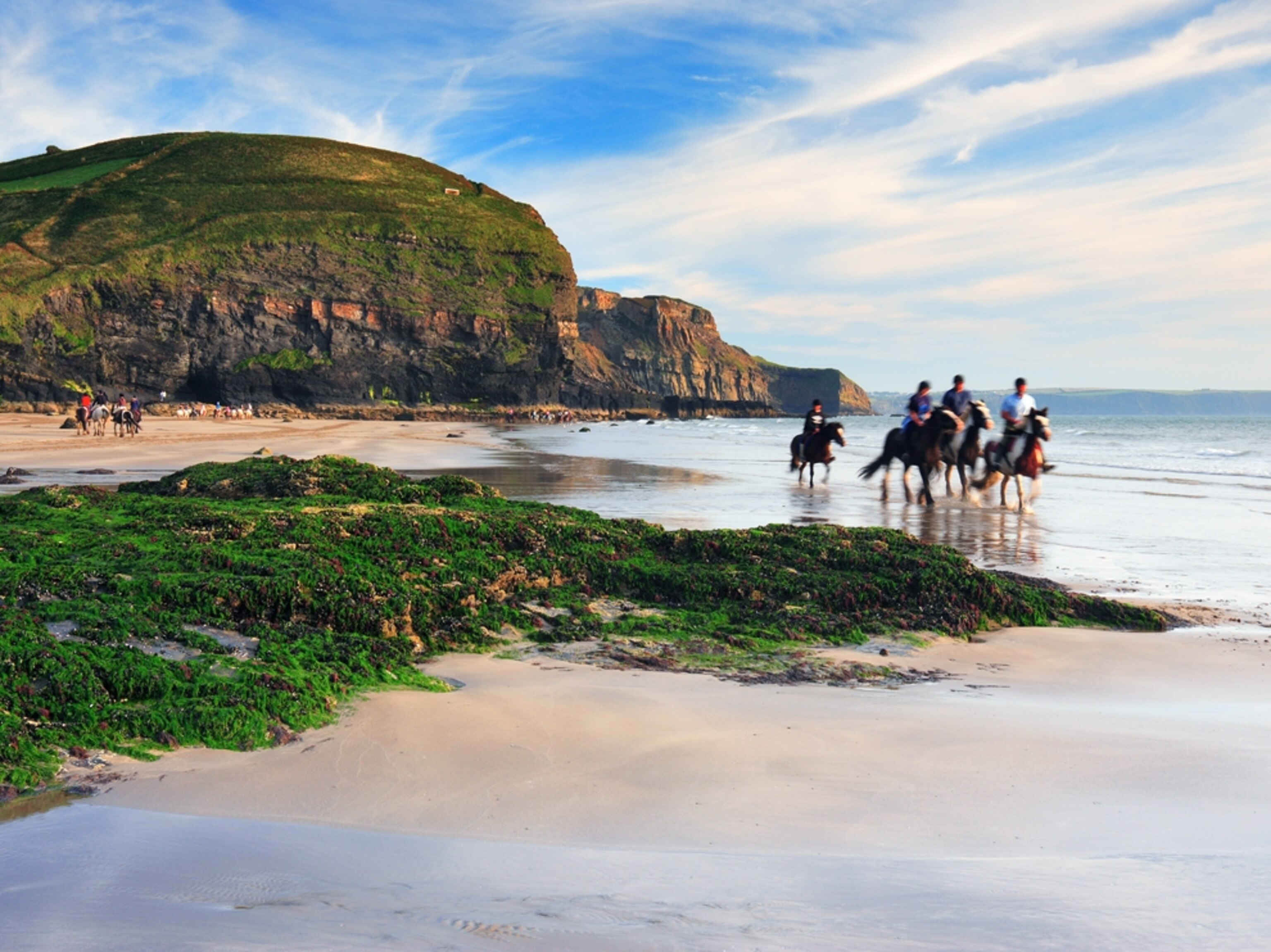 People riding horses on the Pembrokeshire Coast