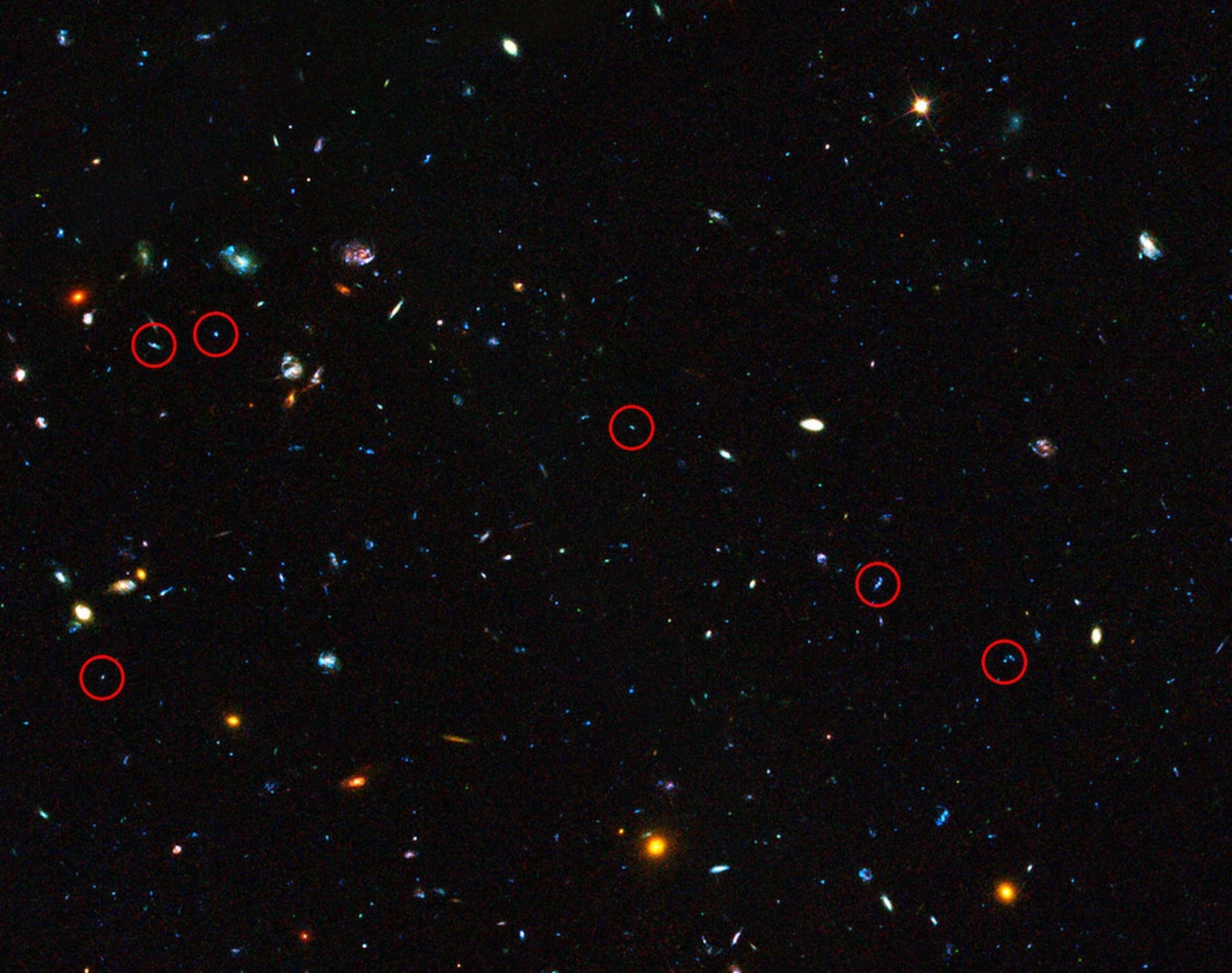 These are some of the dwarf galaxies scientists looked at while peering into the early universe and studying star formation. (NASA/ESA/GOODS Team and M. Giavalisco)